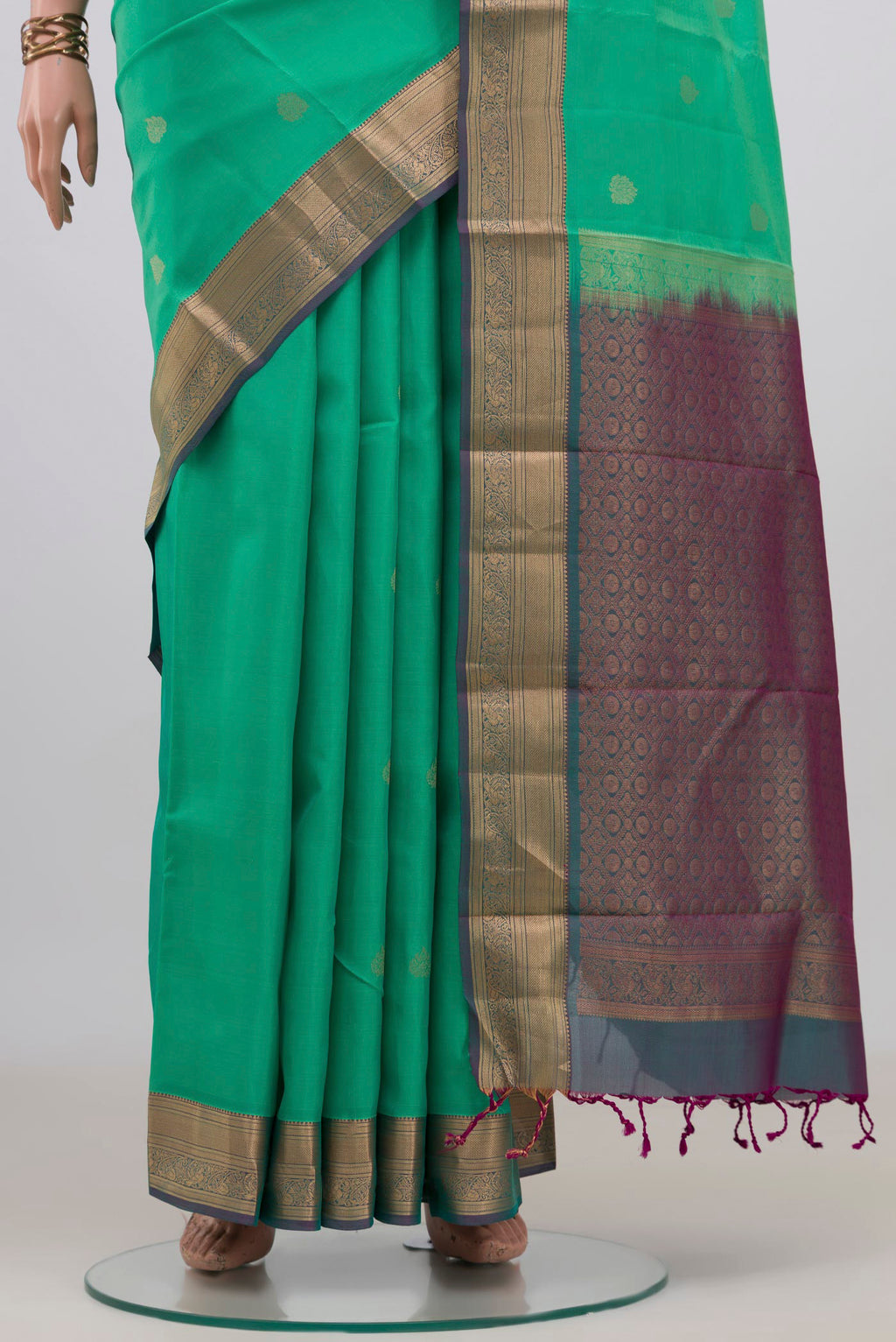 Pleats and pallu of Pure Silk Green Soft Saree with Zari Butta on the body and Zari Border. 