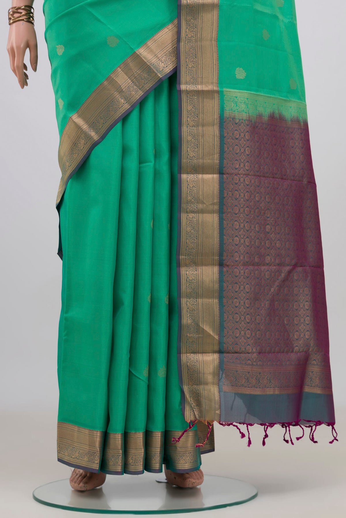 Pleats and pallu of Pure Silk Green Soft Saree with Zari Butta on the body and Zari Border. 