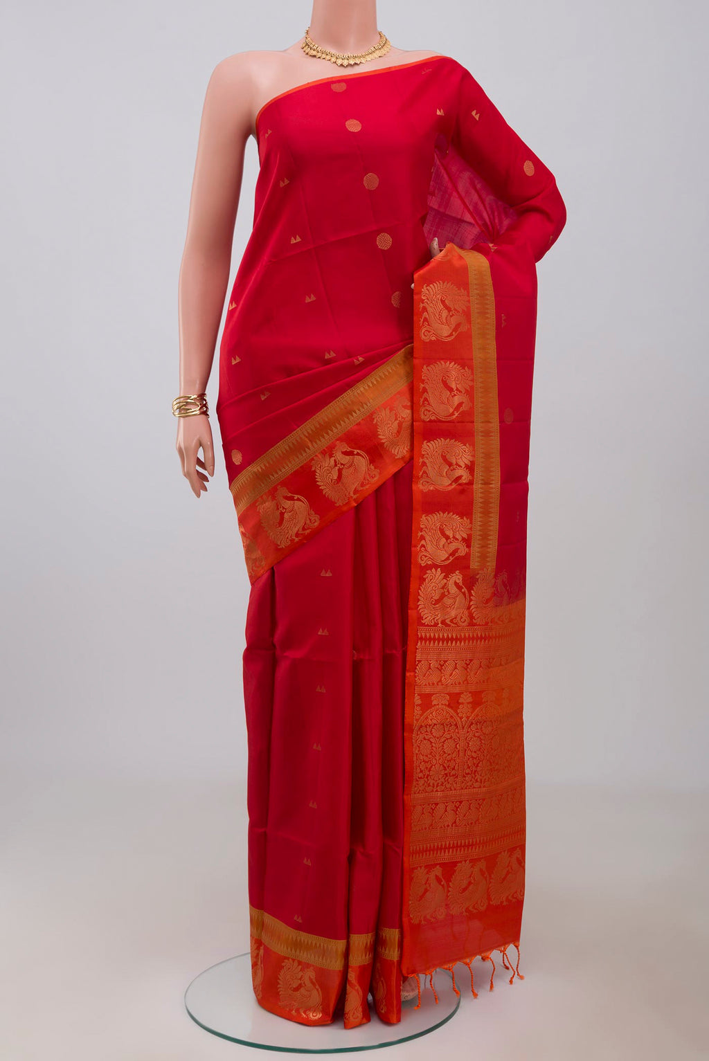 Red Soft Silk Saree with Zari Butta on the body and Fancy Border.  displayed on a mannequin