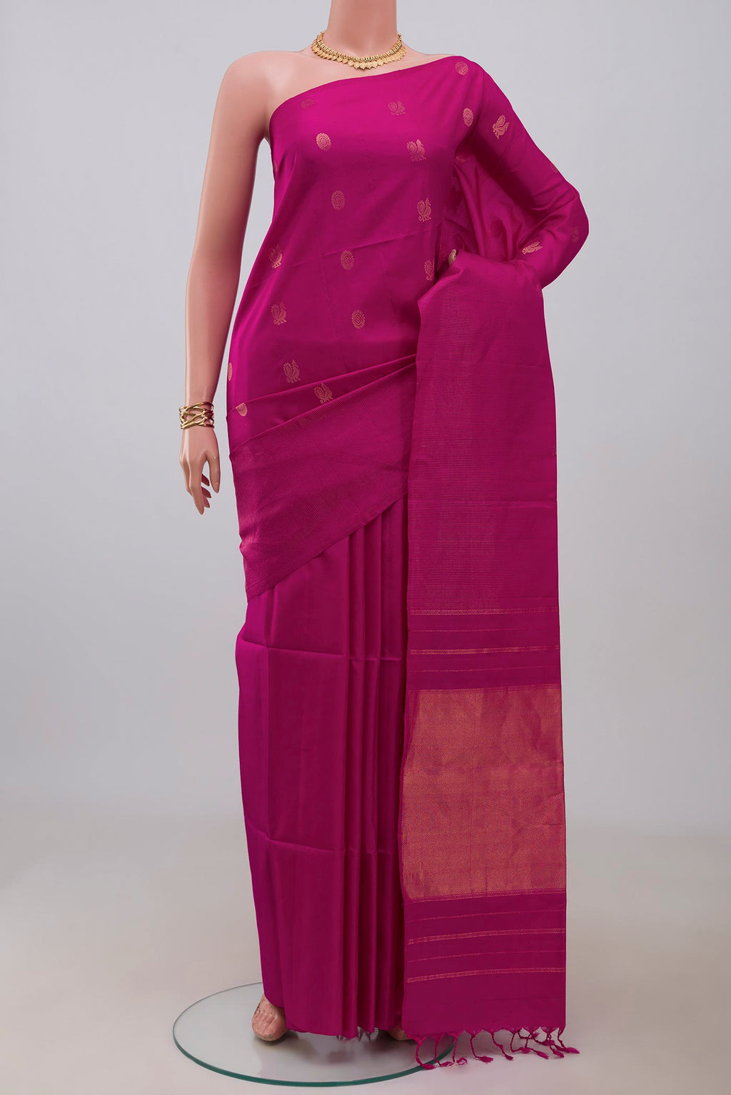 Magenta Soft Silk Saree with Zari Butta on the body and Fancy Border.  displayed on a mannequin