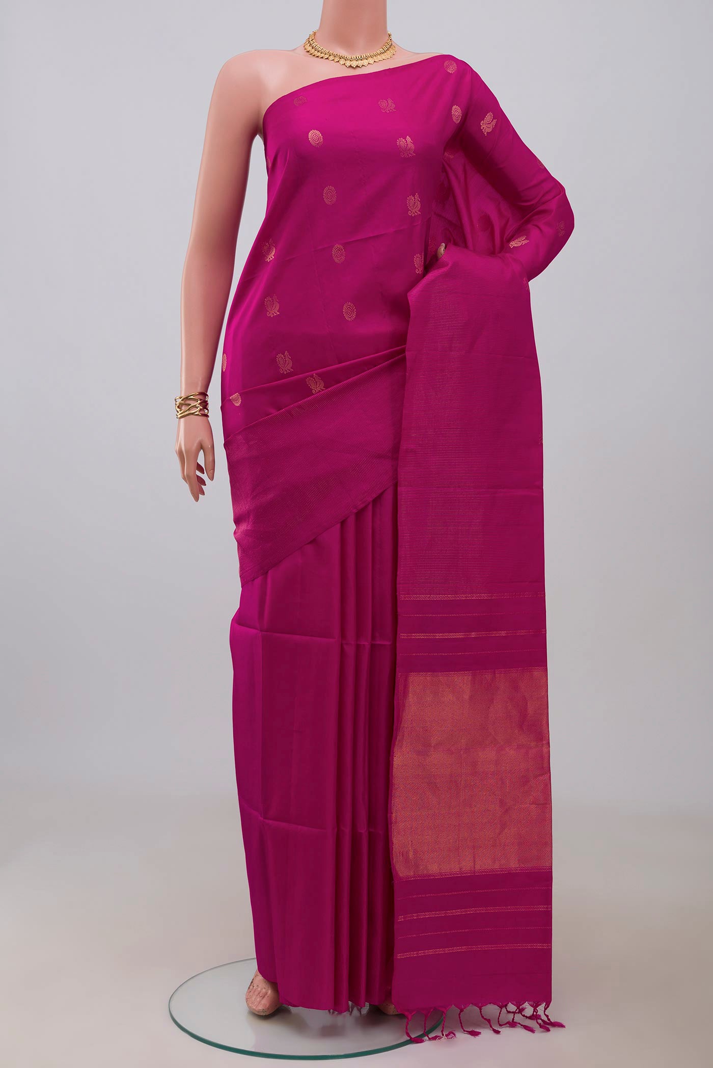 Magenta Soft Silk Saree with Zari Butta on the body and Fancy Border.  displayed on a mannequin