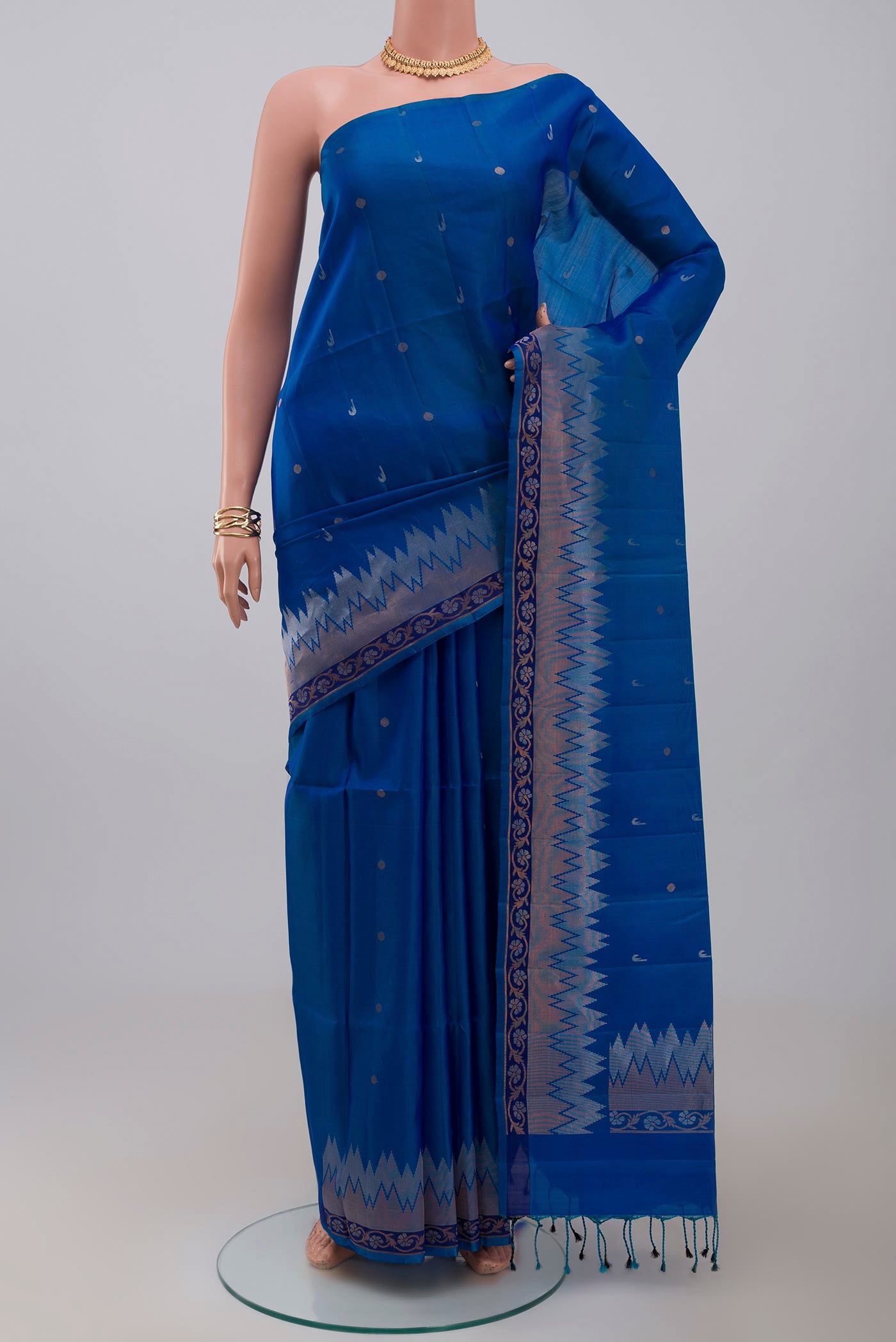 Blue Soft Silk Saree with Zari Butta on the body and Fancy Border.  displayed on a mannequin
