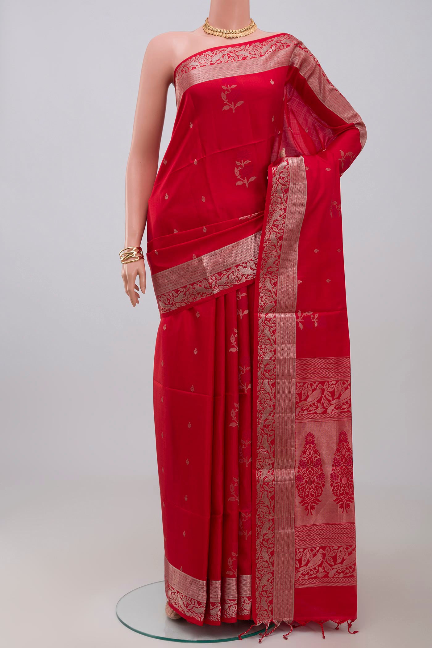 Red Soft Silk Saree with Zari Butta on the body and Zari Border.  displayed on a mannequin