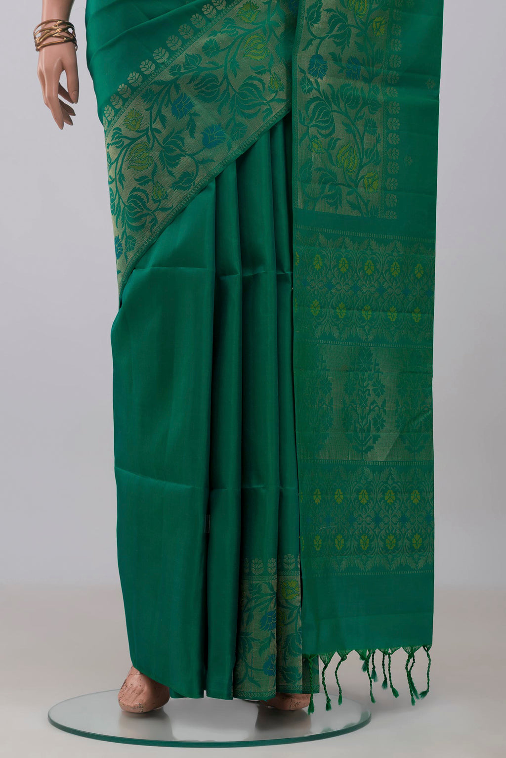 Pleats and pallu of Green Soft Silk Saree with Zari Butta on the body and Zari Border. 