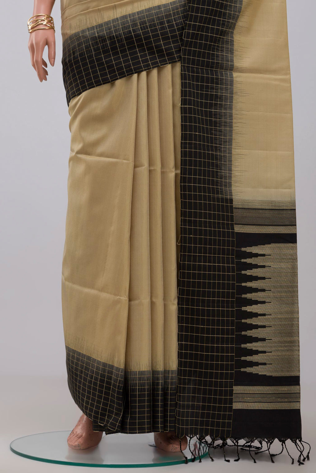 Pleats and pallu of Cream Soft Silk Saree with Plain Body and Ganga Jamuna Border. 