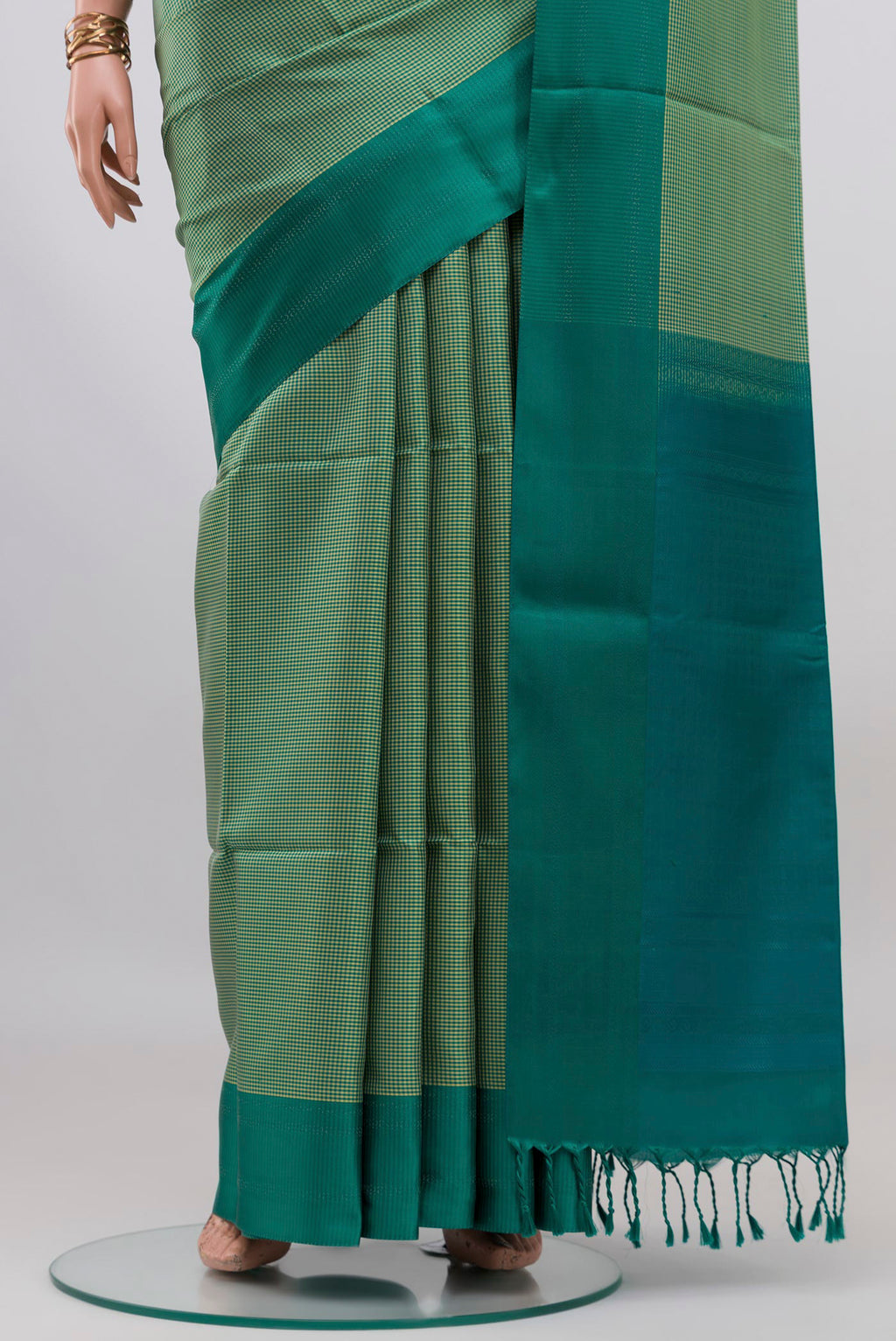 Pleats and pallu of Sage Green Soft Silk Saree with Checked design on the body and Plain Border. 