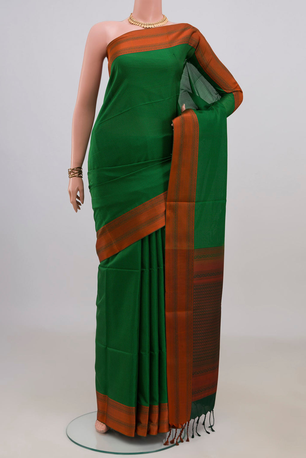 Pure Silk Green Soft Saree with Checked design on the body and Thread Border.  displayed on a mannequin