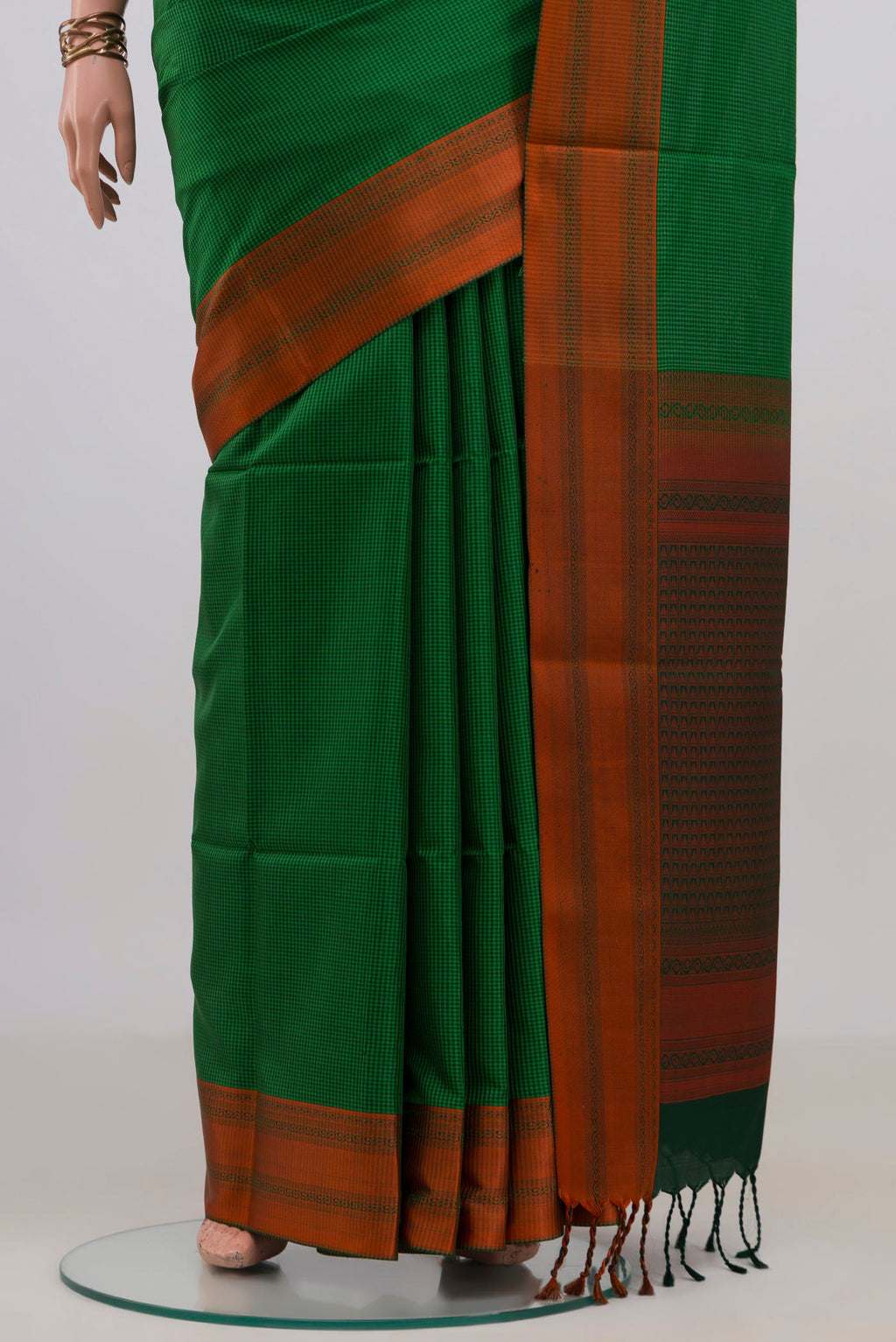 Pleats and pallu of Pure Silk Green Soft Saree with Checked design on the body and Thread Border. 