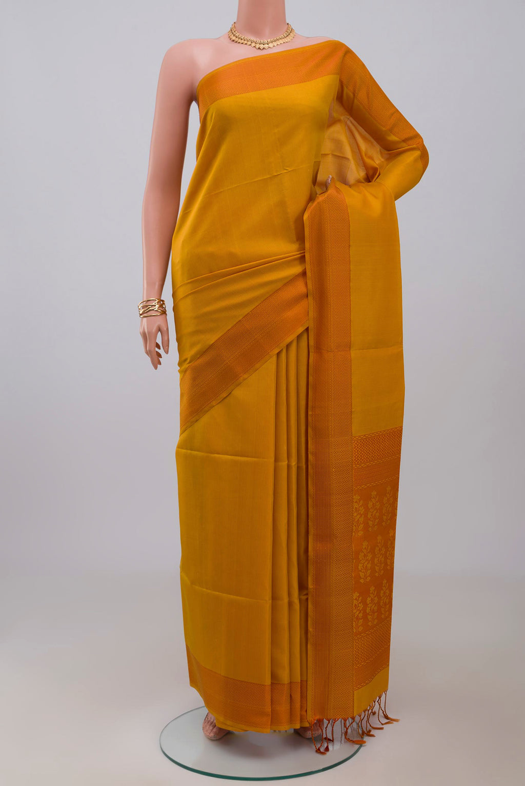 Yellow Soft Silk Saree with Checked design on the body and Thread Border.  displayed on a mannequin