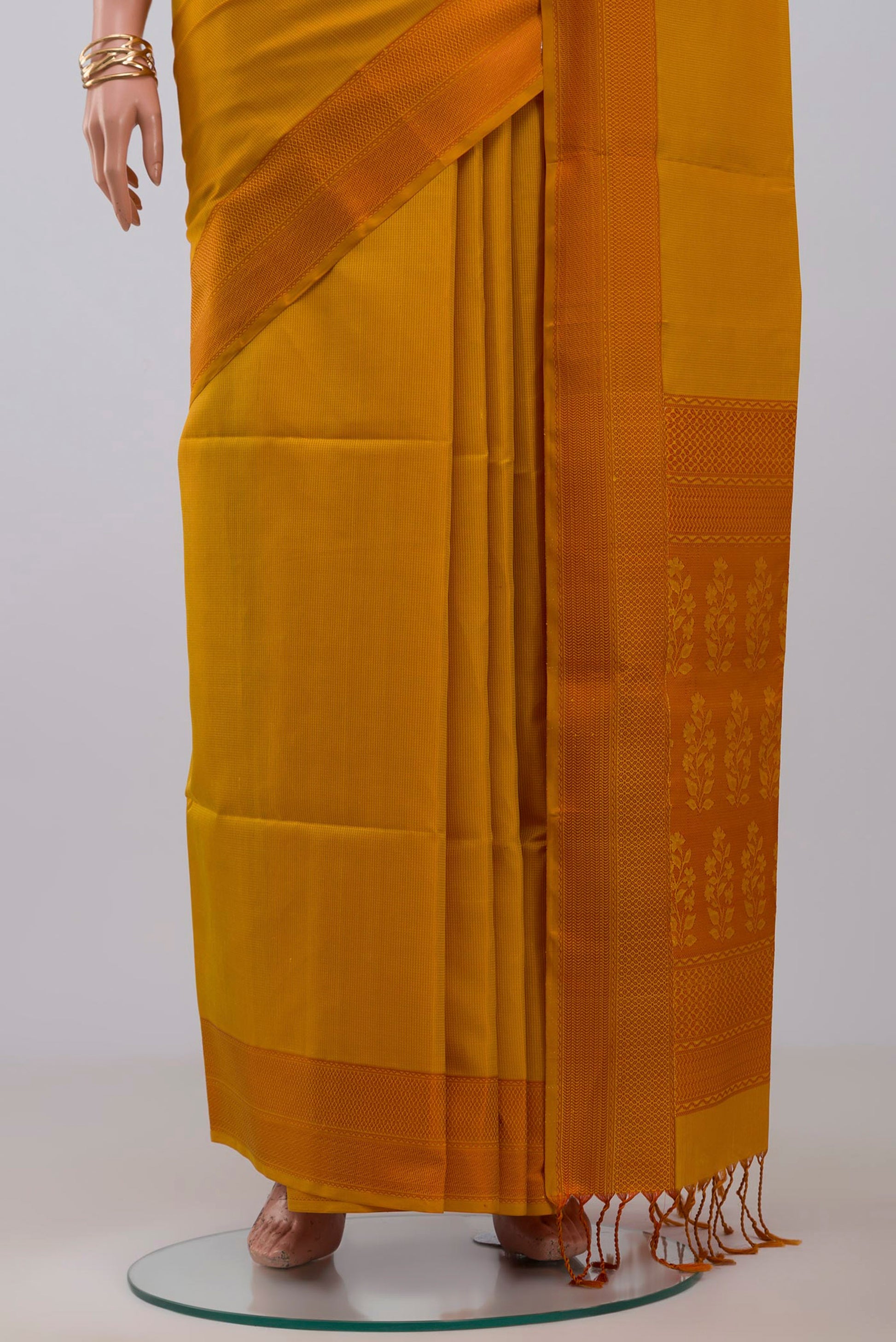 Pleats and pallu of Yellow Soft Silk Saree with Checked design on the body and Thread Border. 
