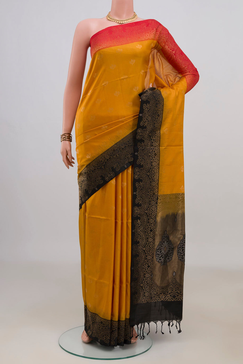 Pure Silk Yellow Soft Saree with Zari Butta on the body and Ganga Jamuna Border.  displayed on a mannequin