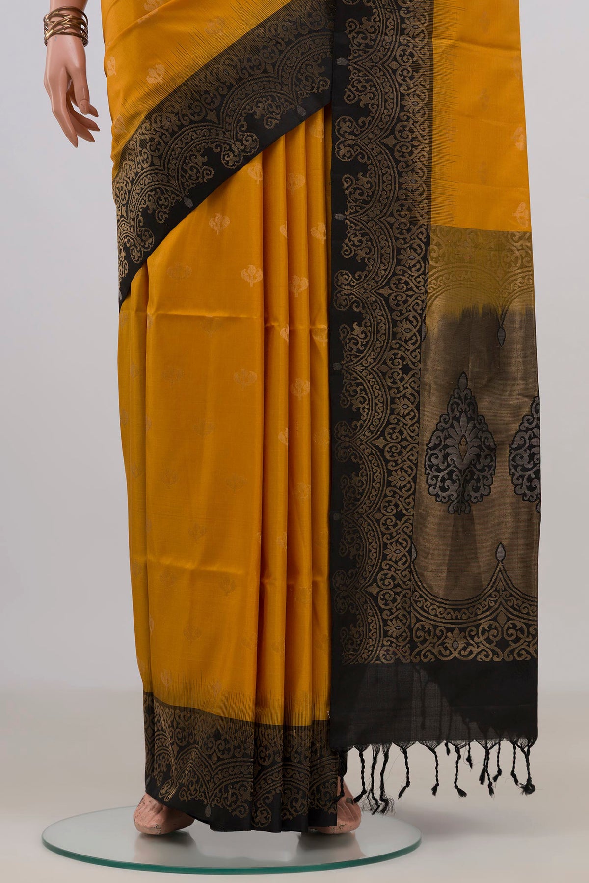 Pleats and pallu of Pure Silk Yellow Soft Saree with Zari Butta on the body and Ganga Jamuna Border. 