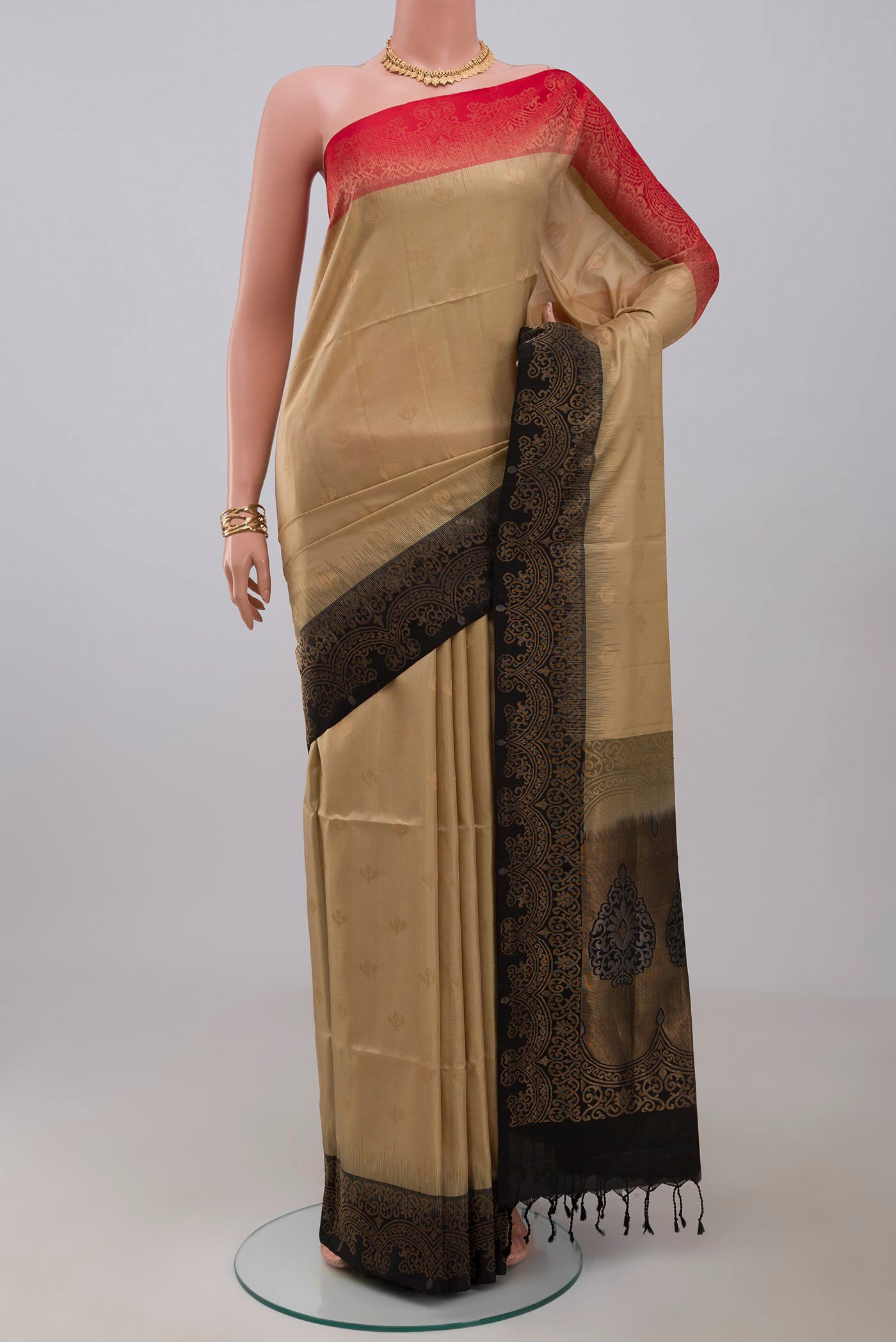 Beige Soft Silk Saree with Zari Butta on the body and Fancy Border.  displayed on a mannequin