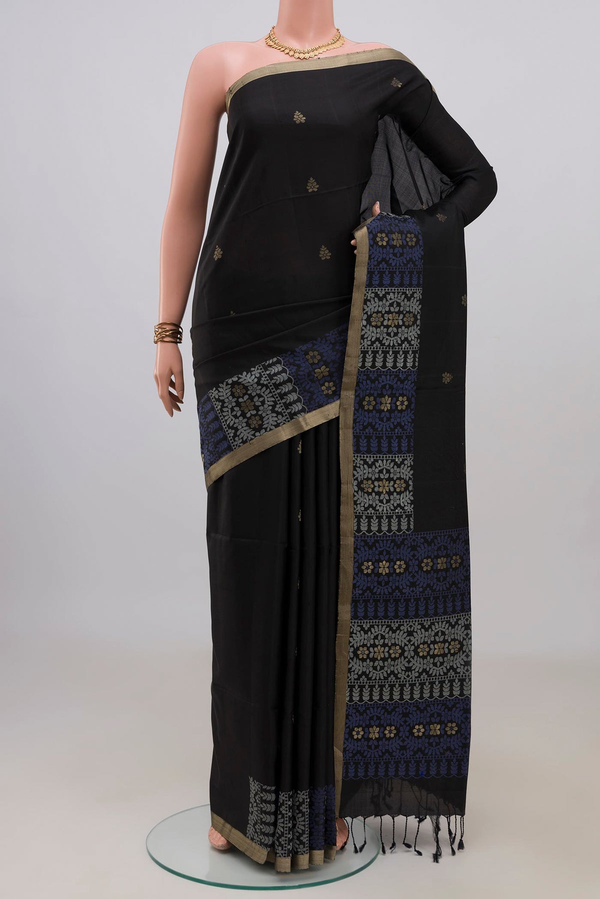Pure Silk Black Soft Saree with Zari Butta on the body and Fancy Border.  displayed on a mannequin