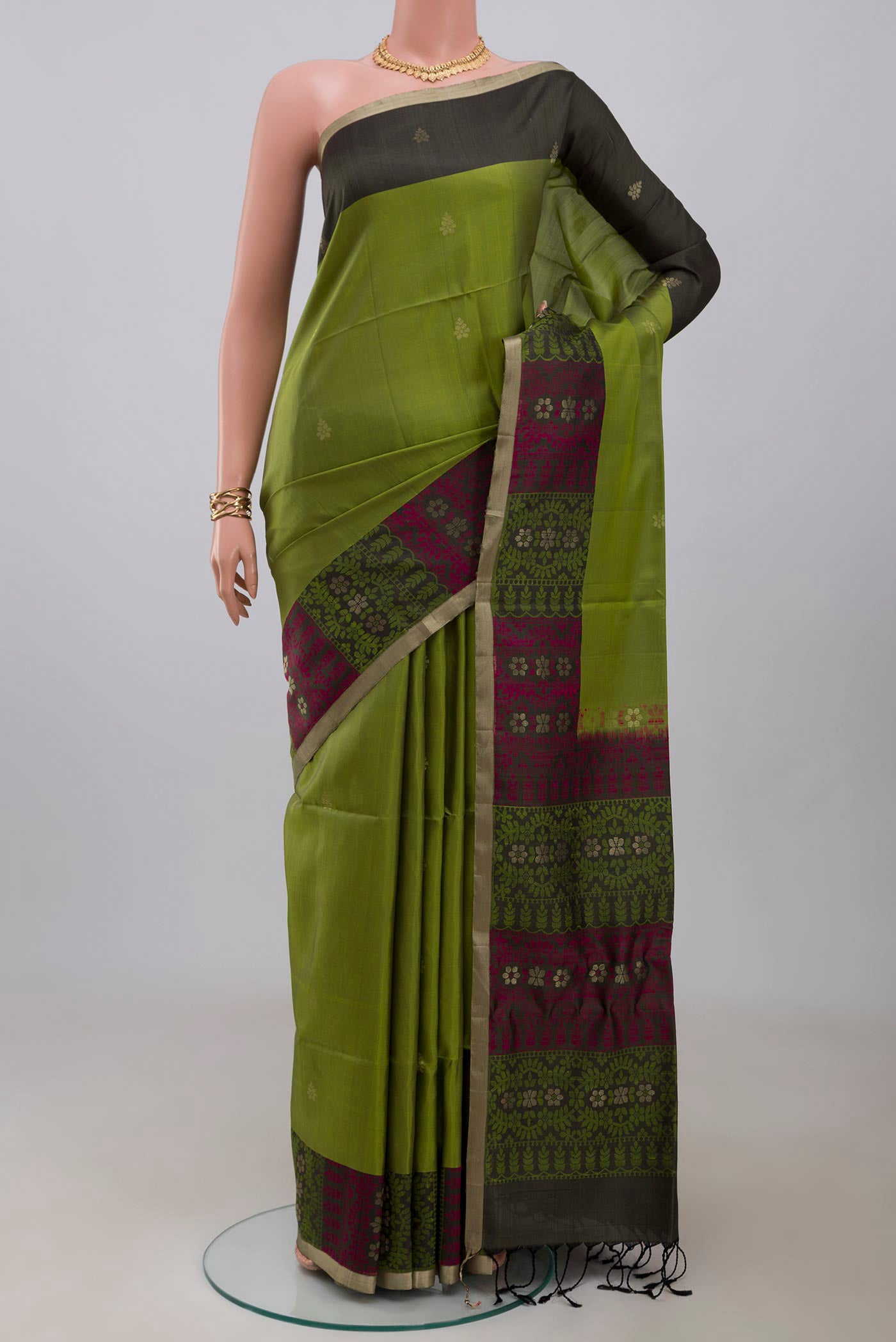 Light Green Soft Silk Saree with Zari Butta on the body and Thread Border.  displayed on a mannequin