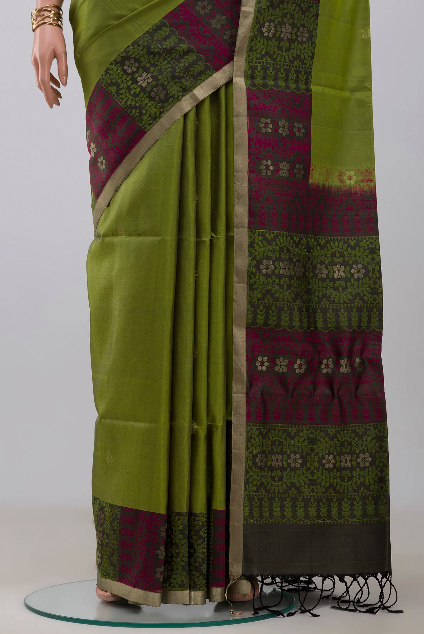 Pleats and pallu of Light Green Soft Silk Saree with Zari Butta on the body and Thread Border. 