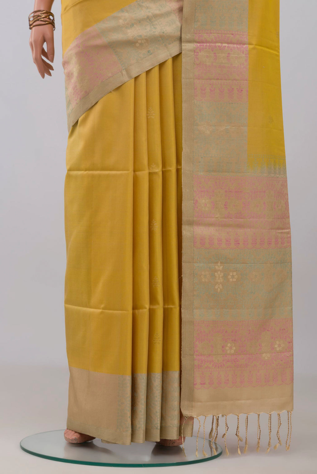 Pleats and pallu of Yellow Soft Silk Saree with Zari Butta on the body and Zari Border. 