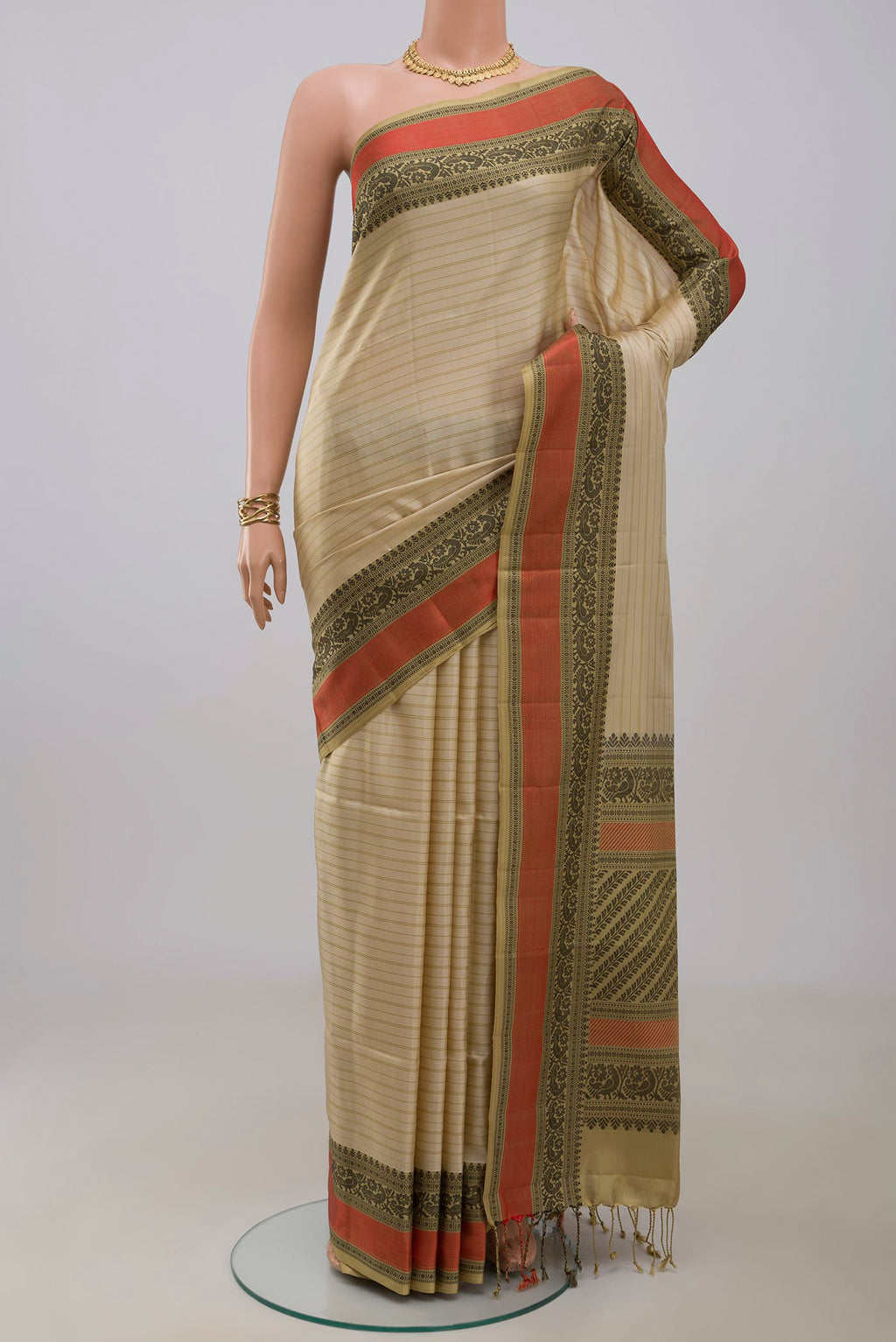 Cream Soft Silk Saree with Stripes on the body and Thread Border.  displayed on a mannequin