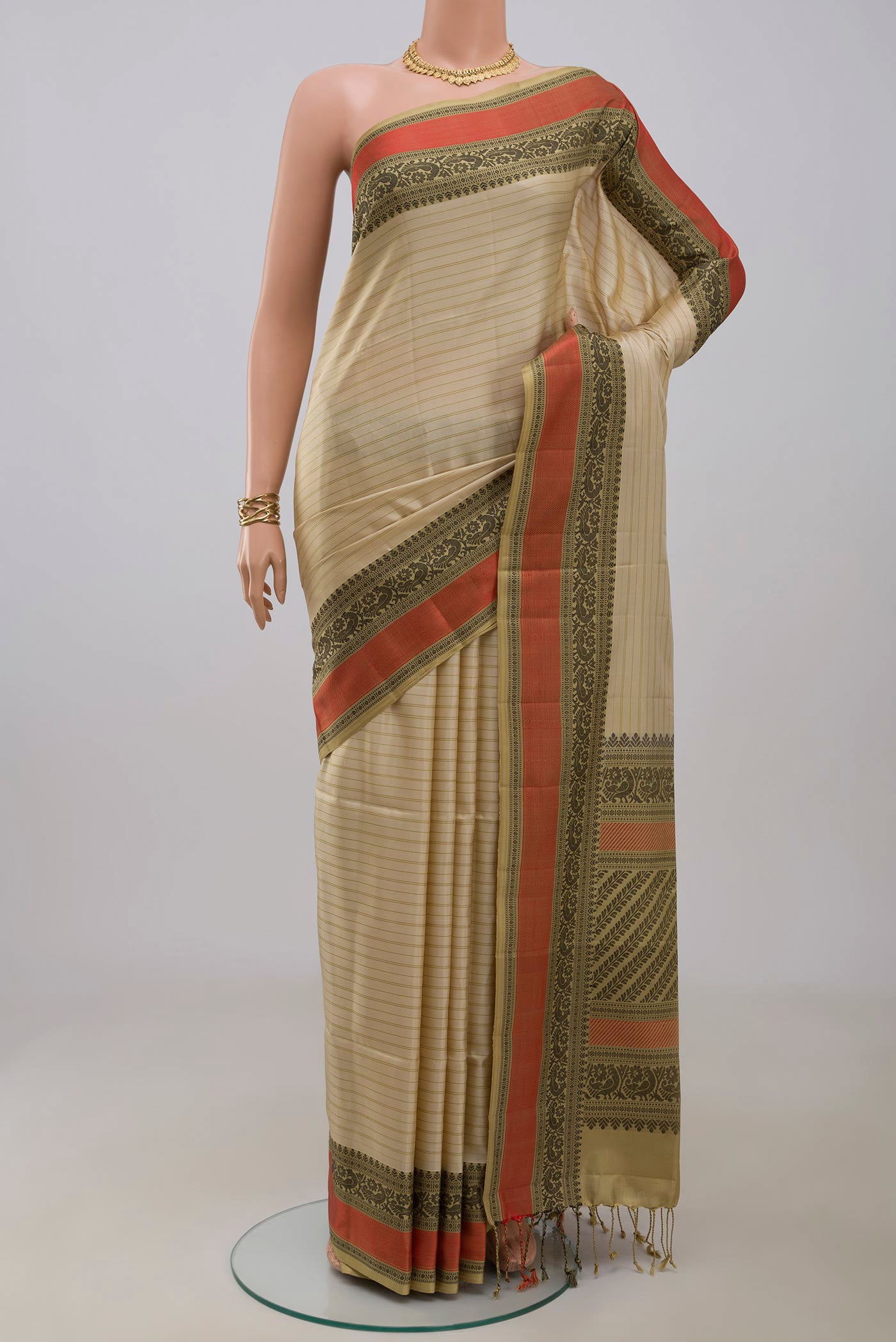 Cream Soft Silk Saree with Stripes on the body and Thread Border.  displayed on a mannequin