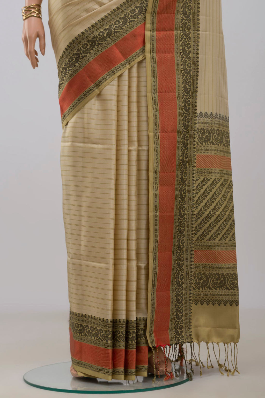 Pleats and pallu of Cream Soft Silk Saree with Stripes on the body and Thread Border. 