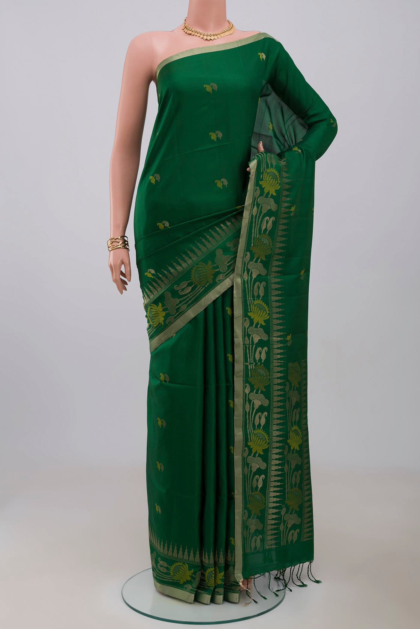 Green Soft Silk Saree with Zari And Thread Butta on the body and Thin Zari Line.  displayed on a mannequin