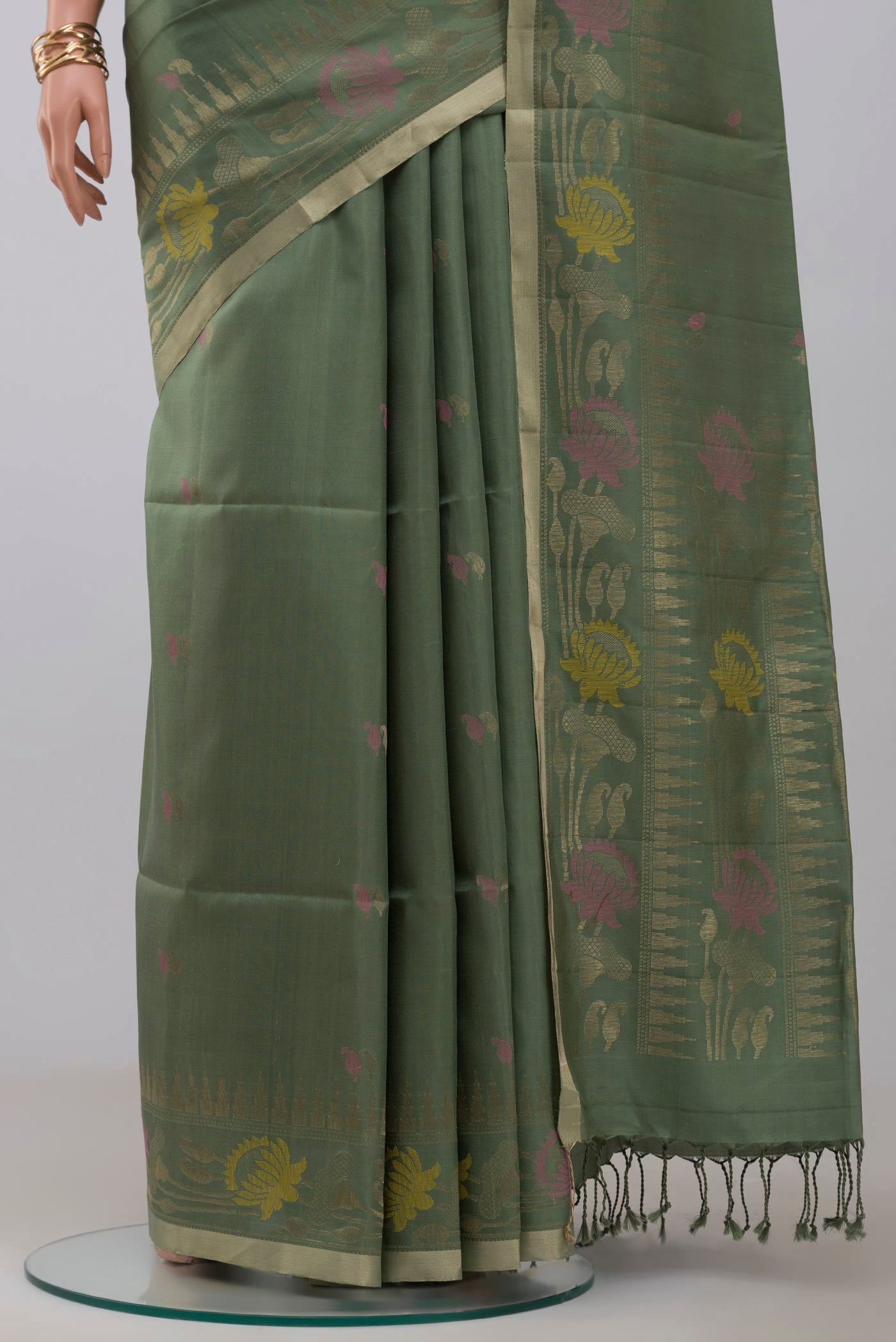 Pleats and pallu of Green Soft Silk Saree with Zari And Thread Butta on the body and Fancy Border. 