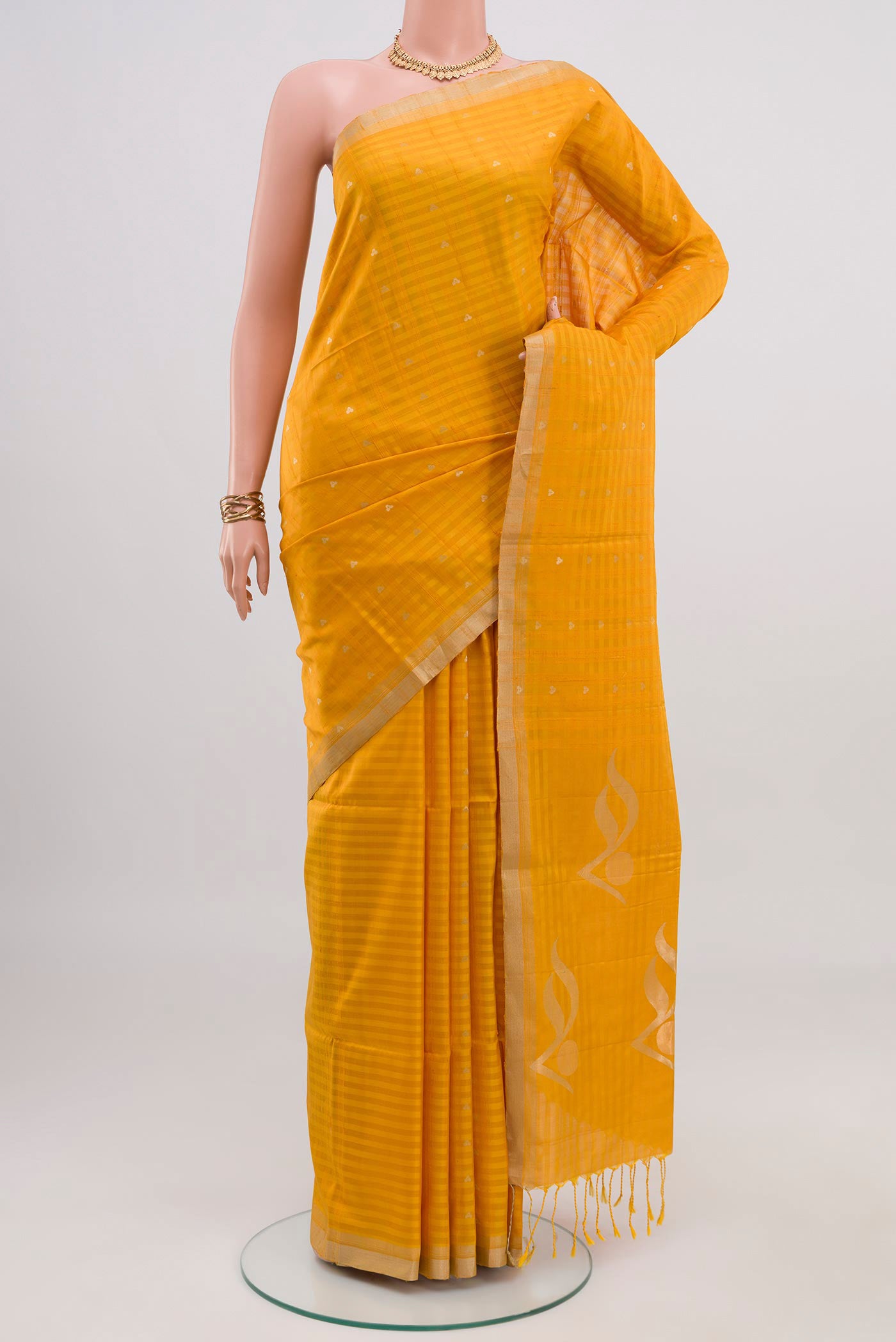 Yellow Soft Silk Saree with Fancy on the body and Thin Zari Line.  displayed on a mannequin