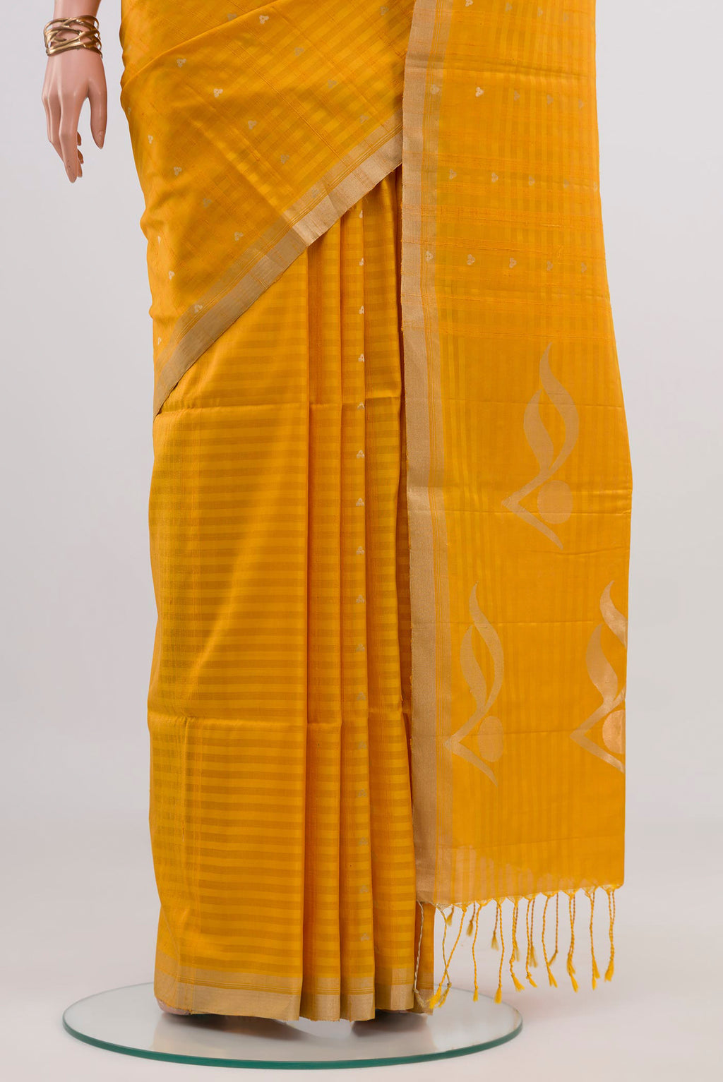 Pleats and pallu of Yellow Soft Silk Saree with Fancy on the body and Thin Zari Line. 