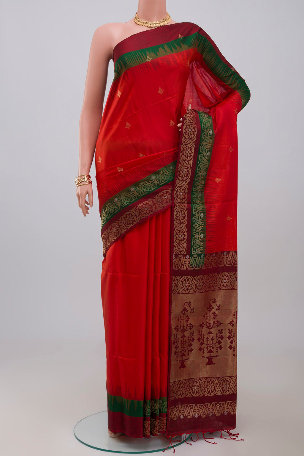 Red Soft Silk Saree with Zari Butta on the body and Fancy Border.  displayed on a mannequin