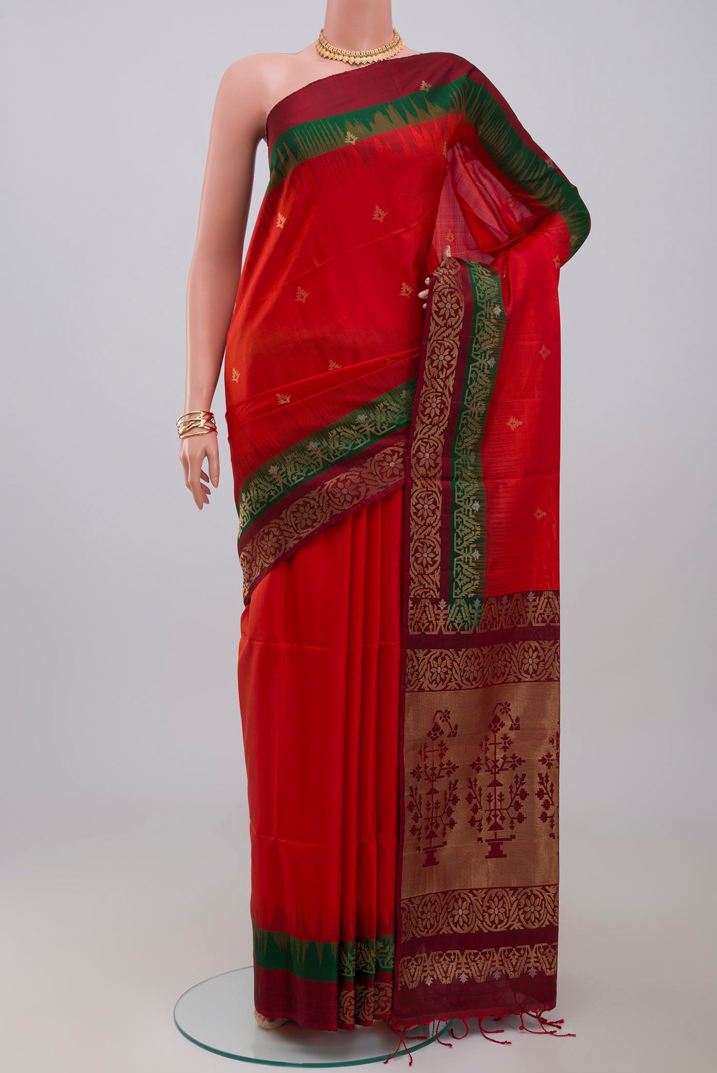 Red Soft Silk Saree with Zari Butta on the body and Fancy Border.  displayed on a mannequin
