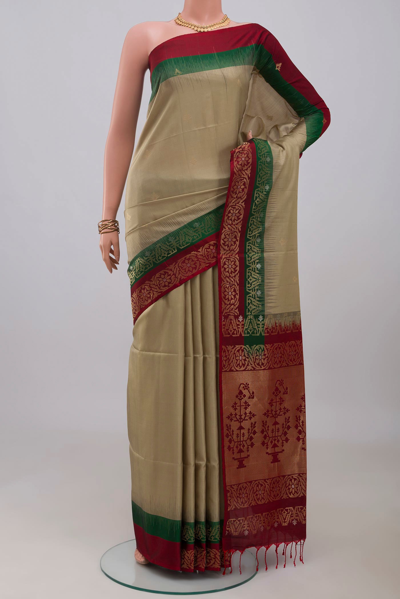 Beige Soft Silk Saree with Zari Butta on the body and Fancy Border.  displayed on a mannequin