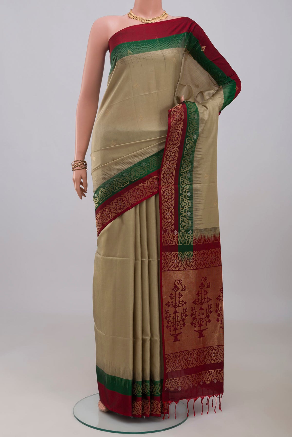 Beige Soft Silk Saree with Zari Butta on the body and Fancy Border.  displayed on a mannequin