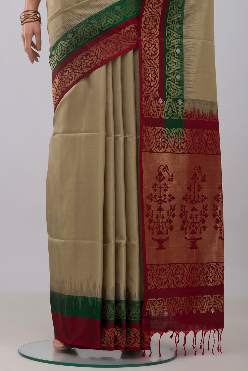 Pleats and pallu of Beige Soft Silk Saree with Zari Butta on the body and Fancy Border. 