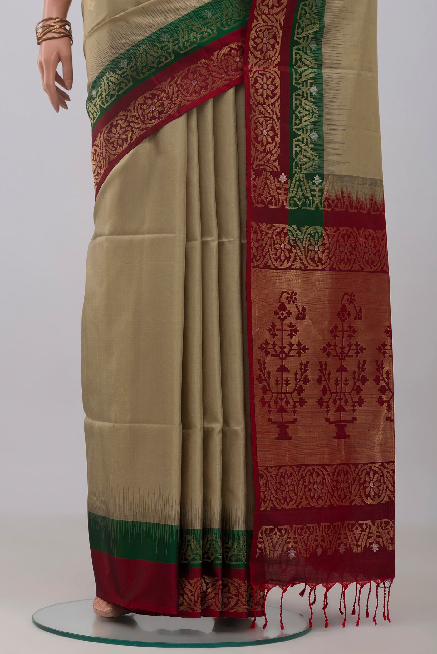 Pleats and pallu of Beige Soft Silk Saree with Zari Butta on the body and Fancy Border. 