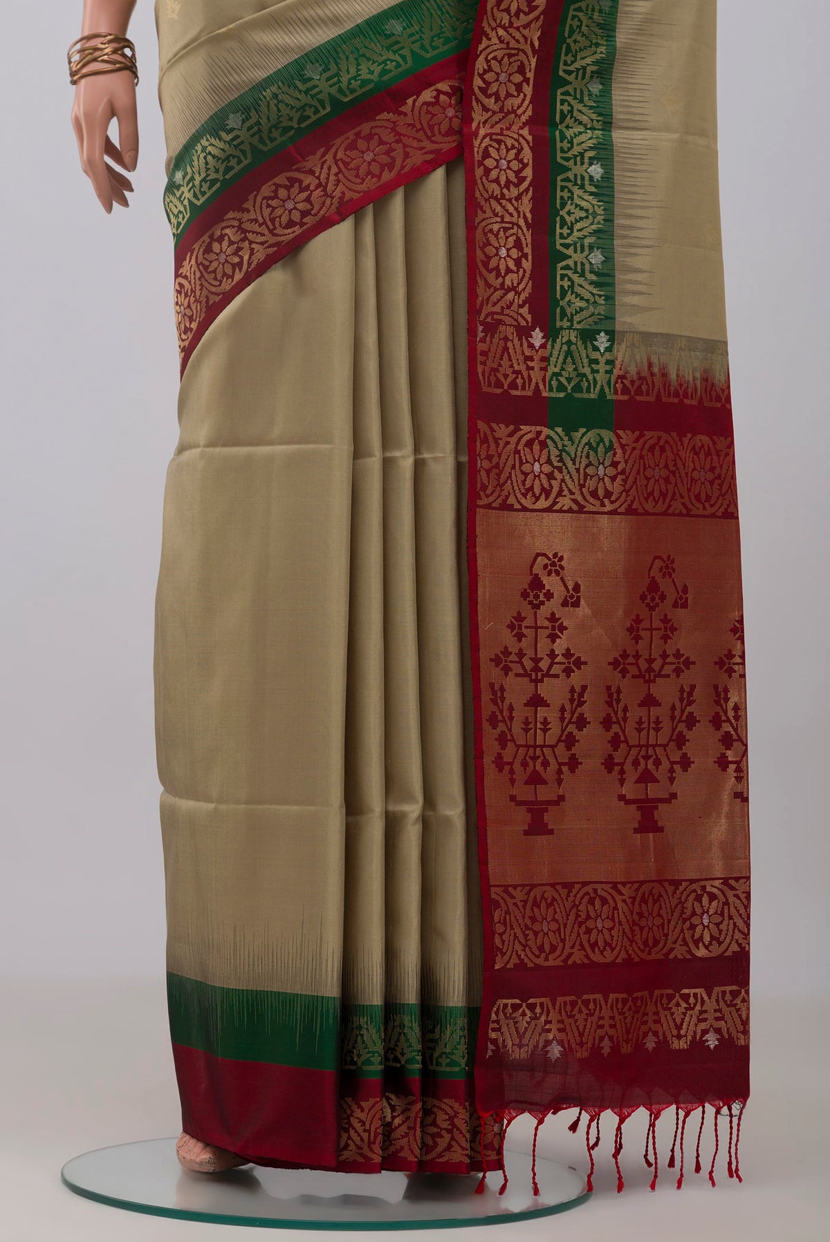 Pleats and pallu of Beige Soft Silk Saree with Zari Butta on the body and Fancy Border. 