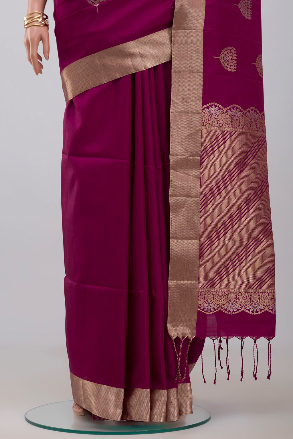 Pleats and pallu of Purple Soft Silk Saree with Zari Butta on the body and Zari Border. 