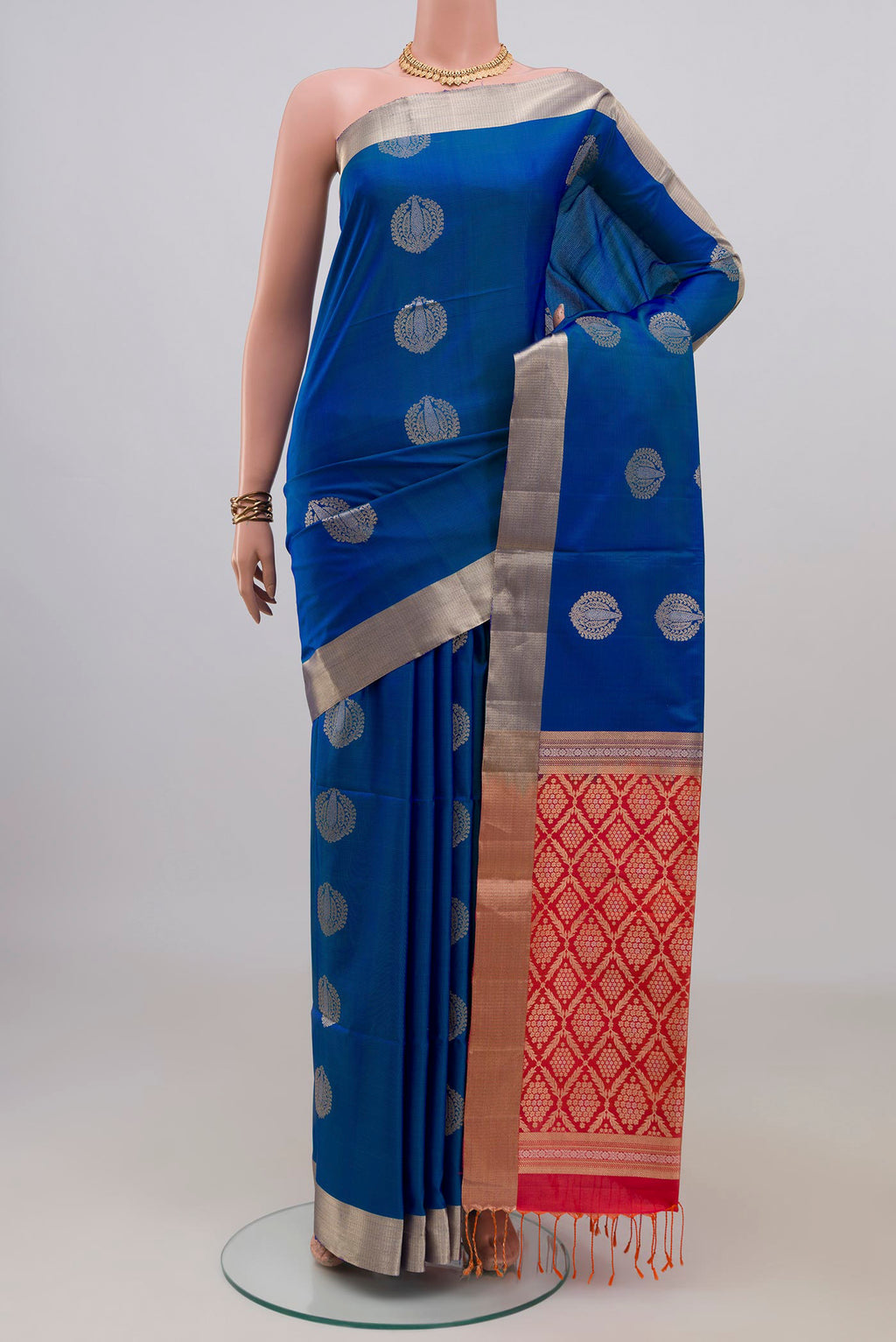 Pure Silk Blue Soft Saree with Zari Butta on the body and Zari Border.  displayed on a mannequin