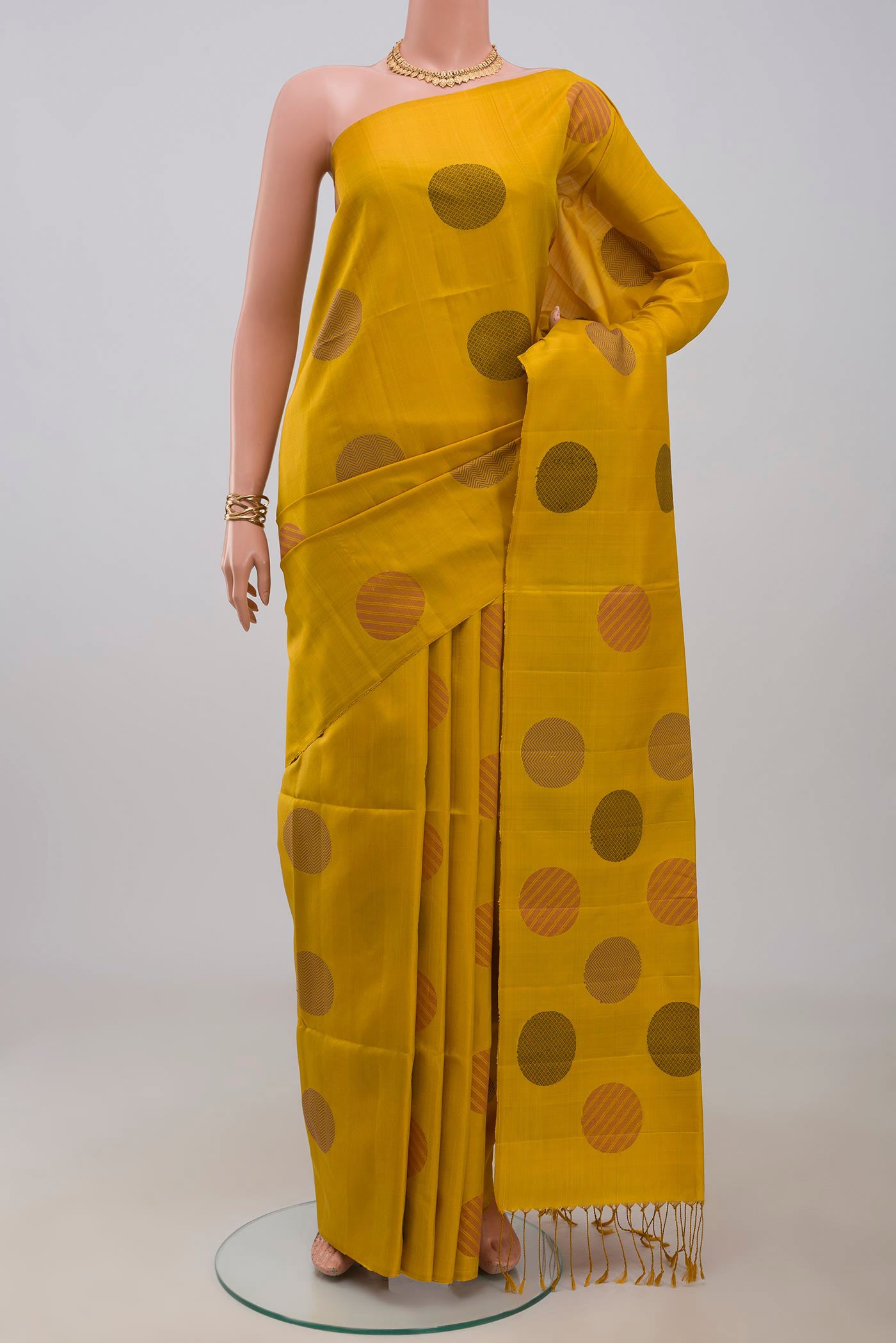 Yellow Soft Silk Saree with Thread Butta on the body and Without Border.  displayed on a mannequin