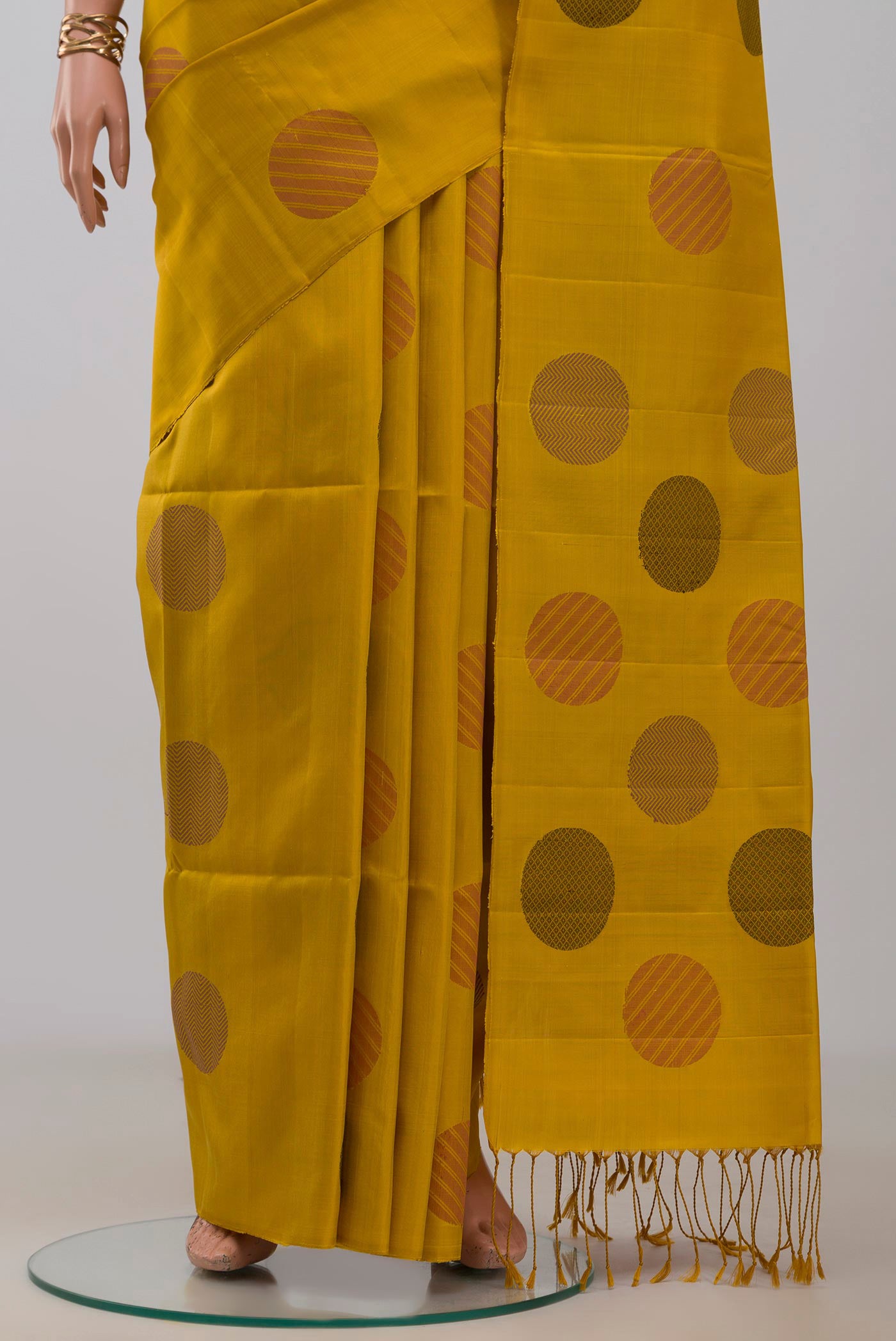 Pleats and pallu of Yellow Soft Silk Saree with Thread Butta on the body and Without Border. 