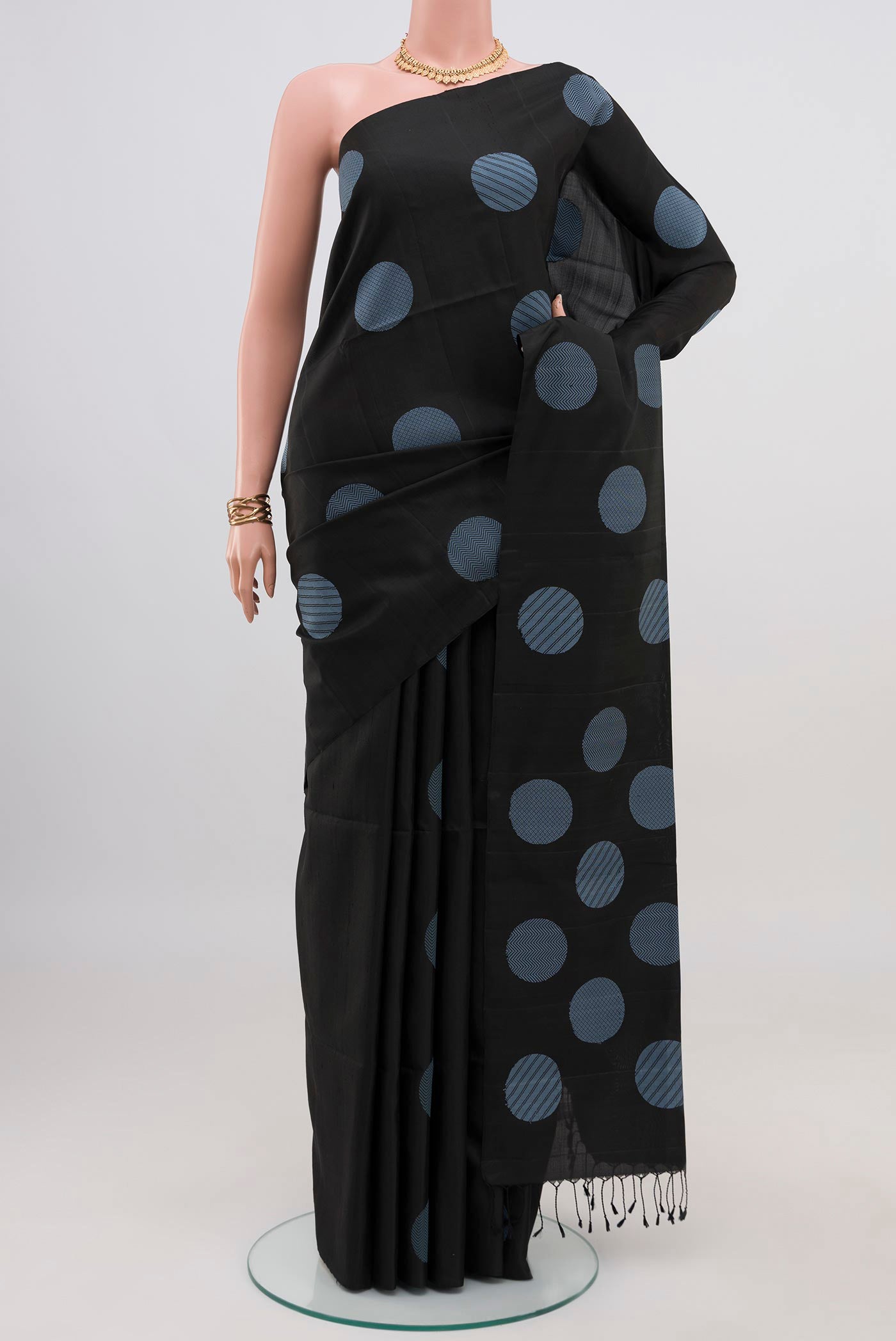 Black Soft Silk Saree with Fancy on the body and Without Border.  displayed on a mannequin