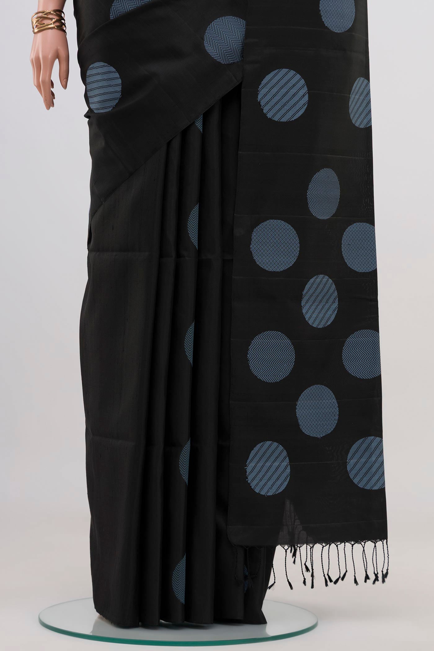 Pleats and pallu of Black Soft Silk Saree with Fancy on the body and Without Border. 