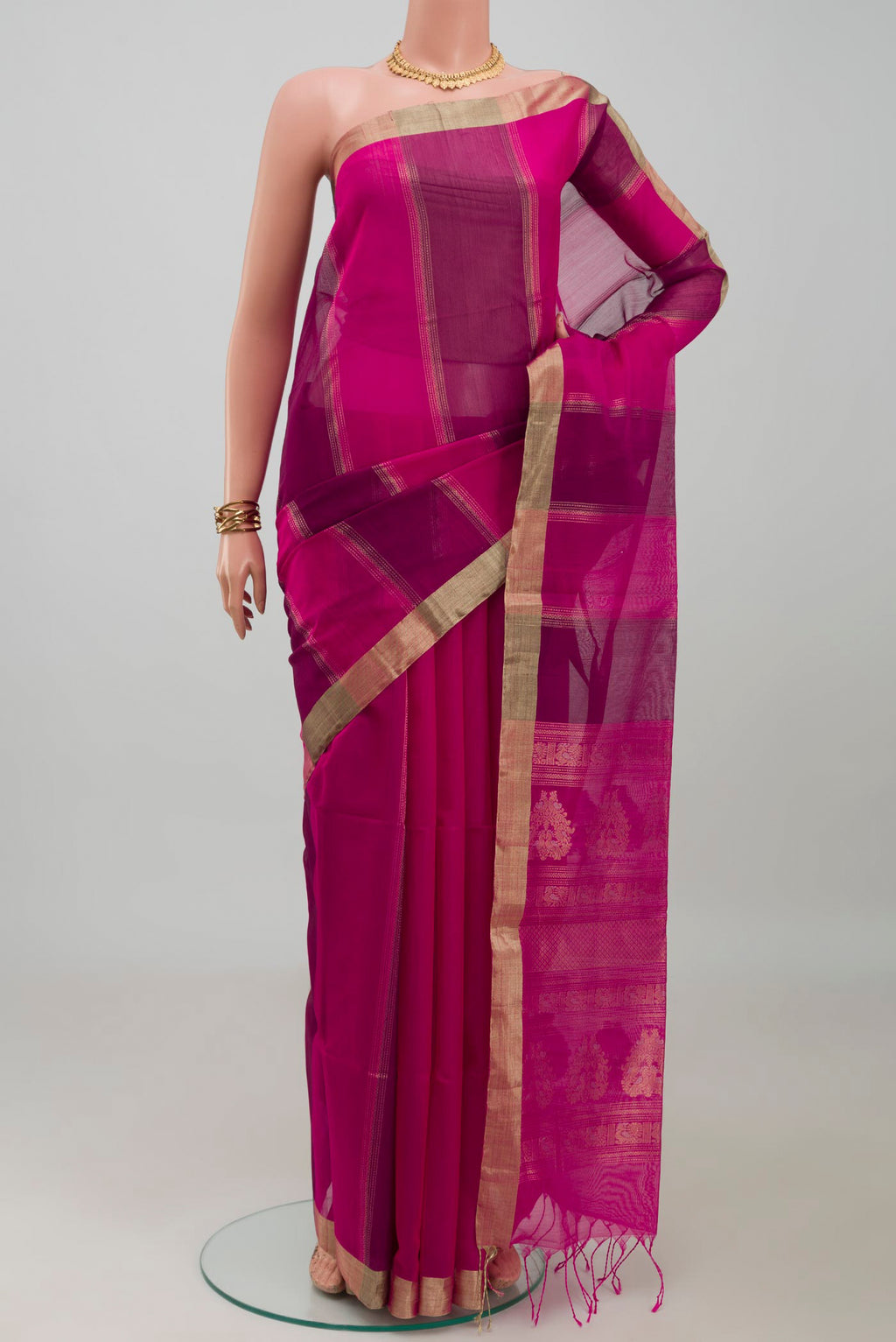 Magenta Silk Cotton Saree with Stripes on the body and Zari Border.  displayed on a mannequin