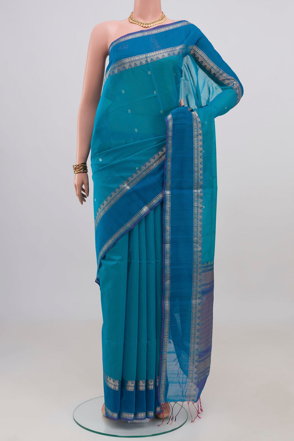Blue Silk Cotton Saree with Zari Butta on the body and Zari Border.  displayed on a mannequin