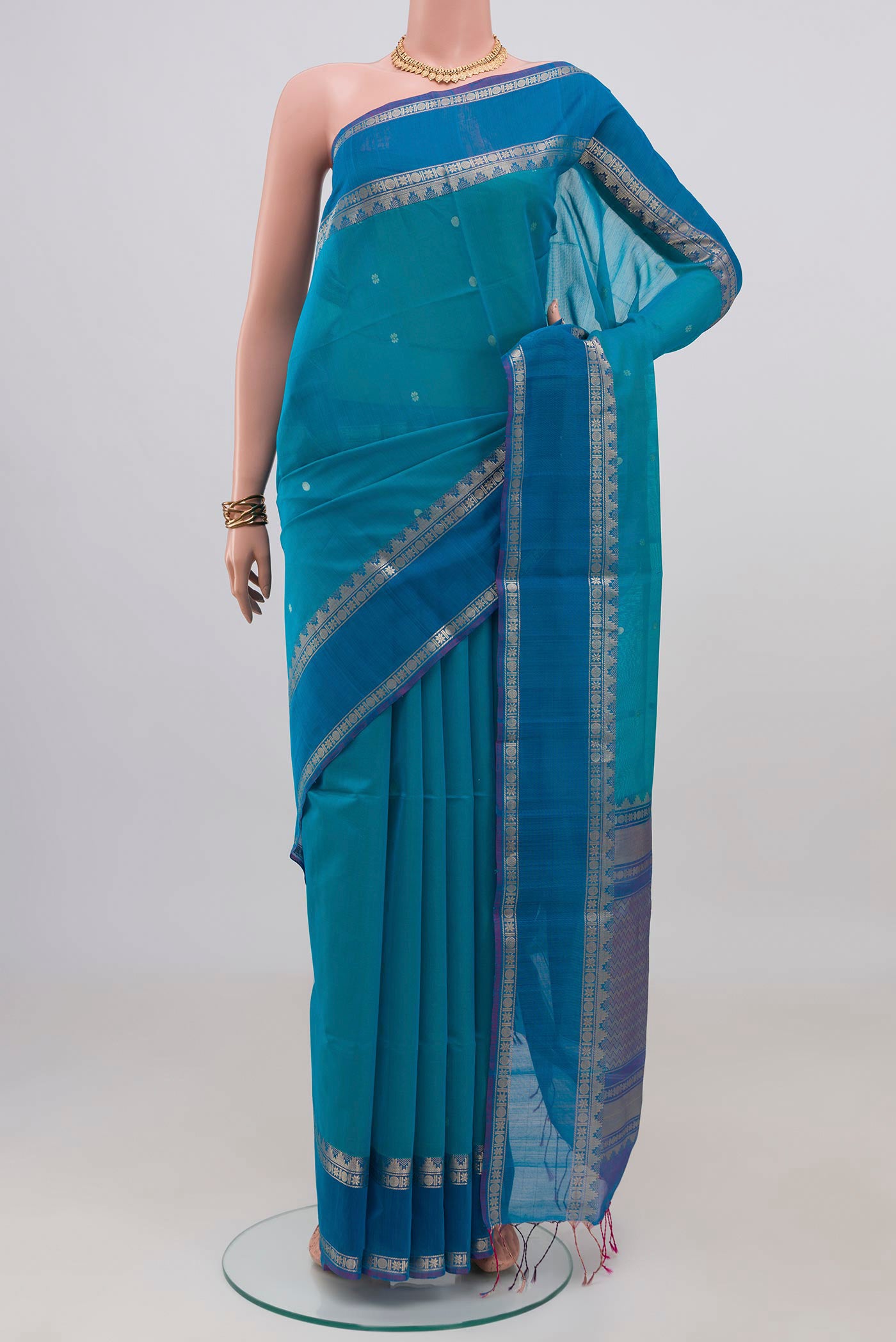 Blue Silk Cotton Saree with Zari Butta on the body and Zari Border.  displayed on a mannequin