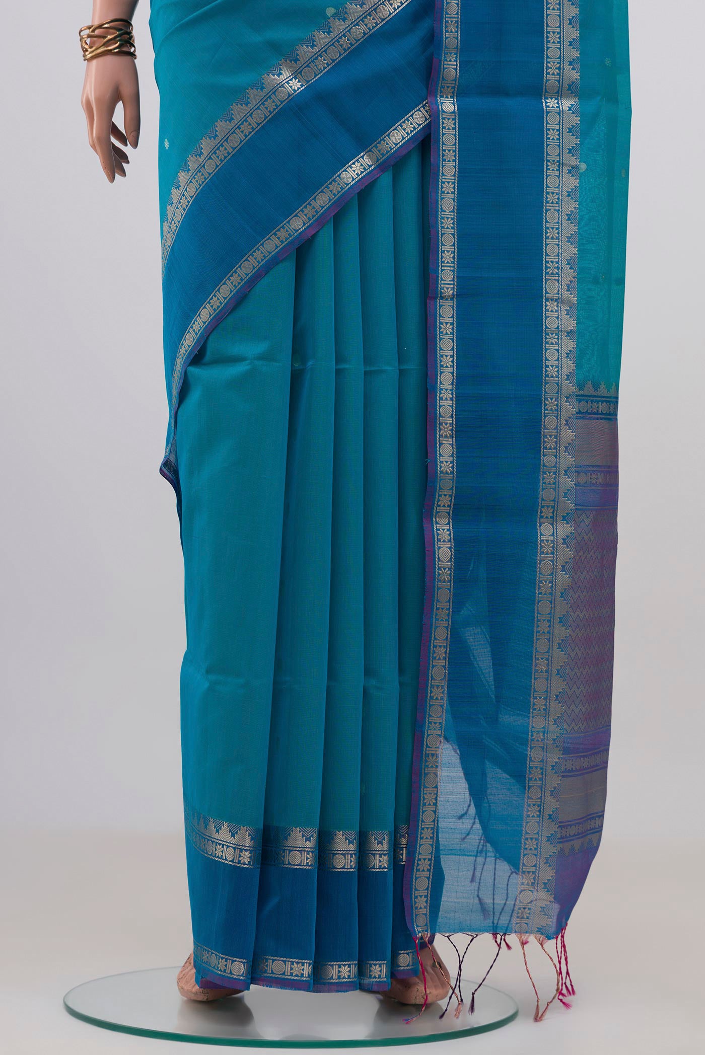 Pleats and pallu of Blue Silk Cotton Saree with Zari Butta on the body and Zari Border. 