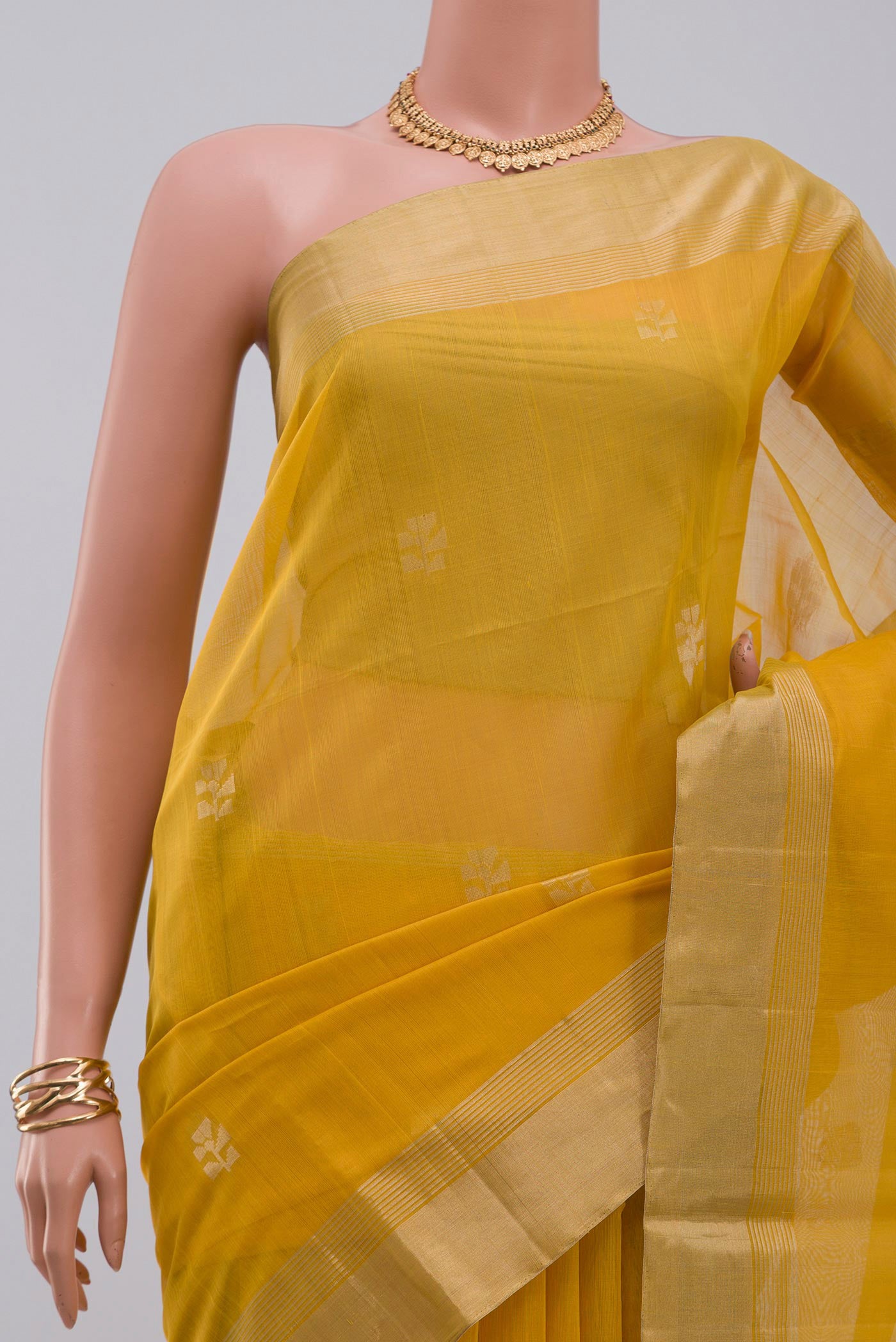Border image of Yellow Silk Cotton Saree with Zari Butta on the body and Zari Border. 