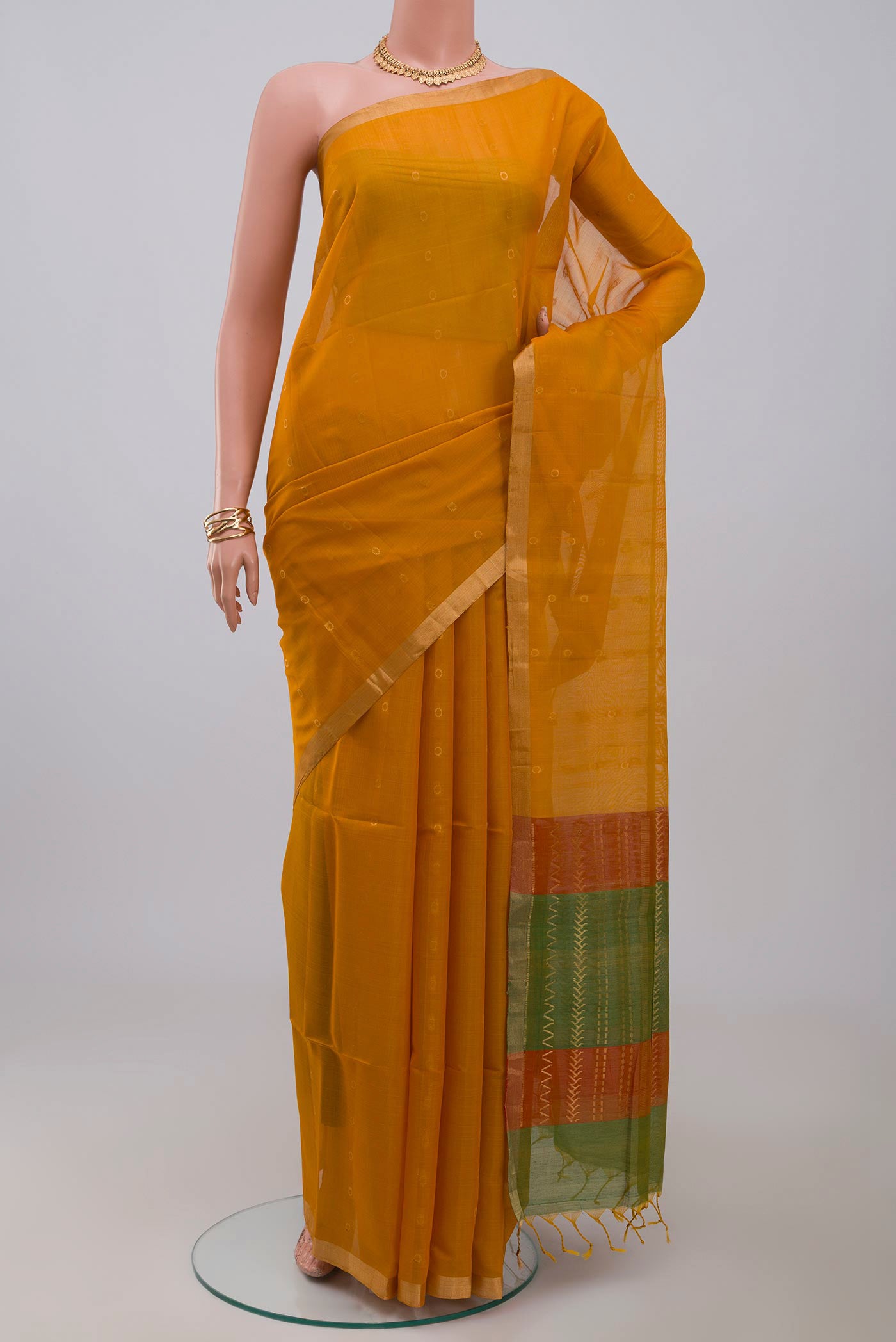 Yellow Silk Cotton Saree with Zari Butta on the body and Thin Zari Line.  displayed on a mannequin