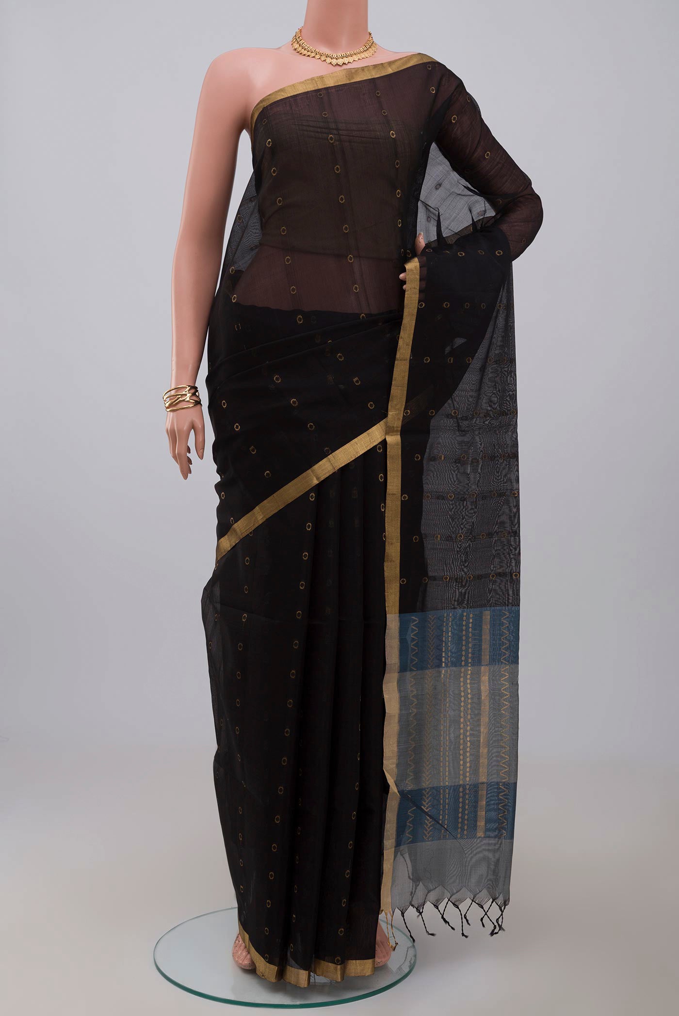 Black Silk Cotton Saree with Zari Butta on the body and Thin Zari Line.  displayed on a mannequin