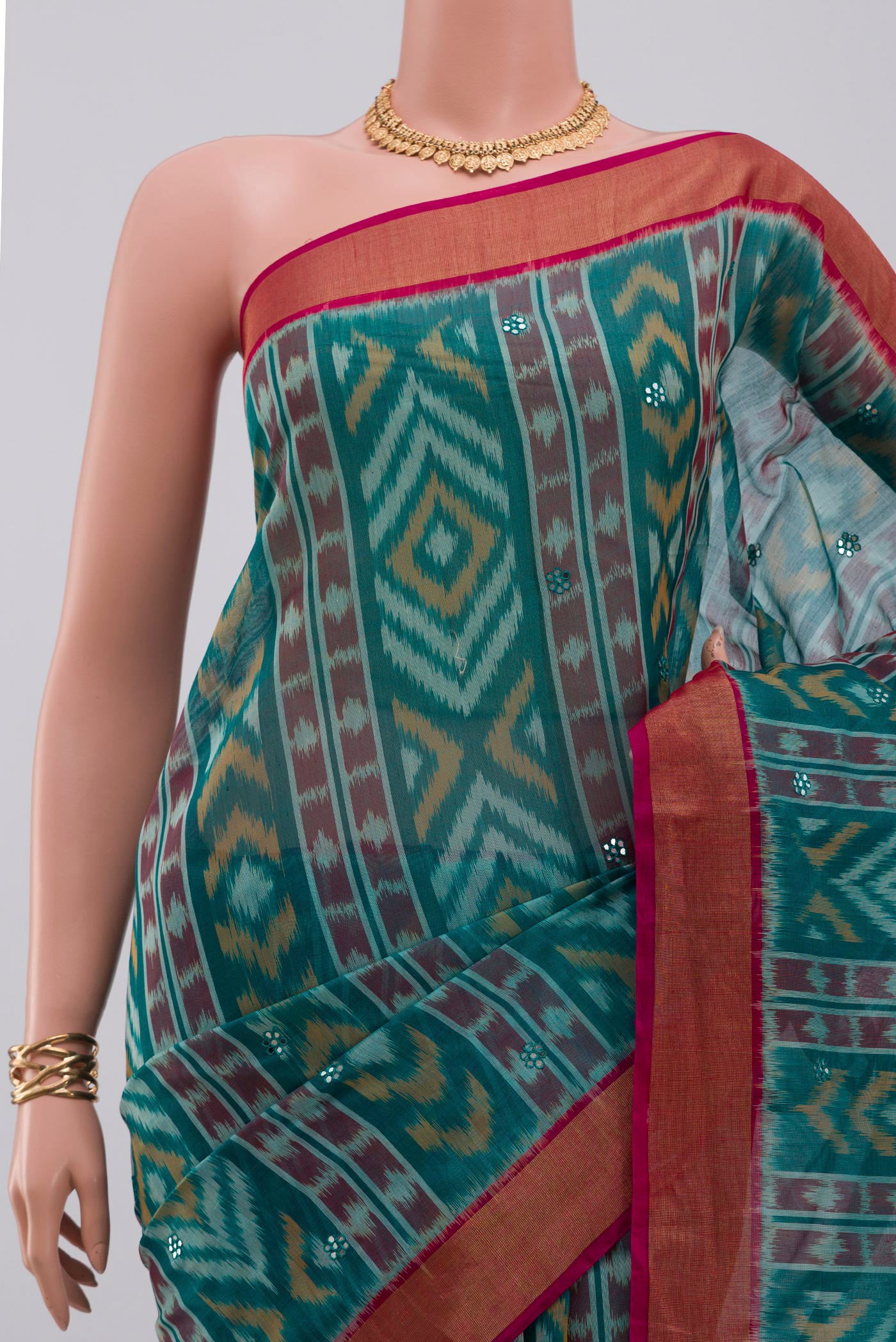 Border image of Green Silk Cotton Saree with Ikat Print on the body and Zari Border. 