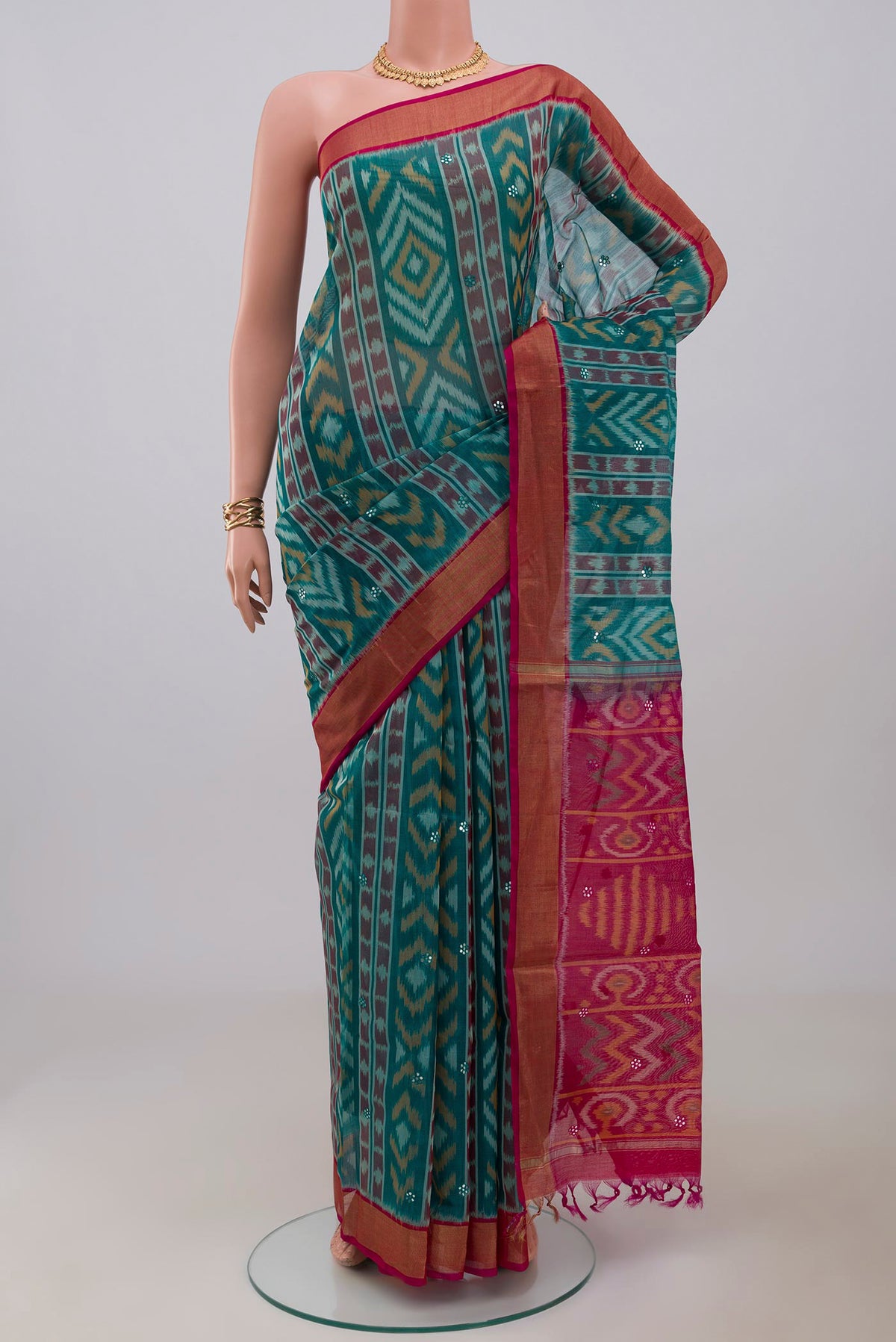 Green Silk Cotton Saree with Ikat Print on the body and Zari Border.  displayed on a mannequin
